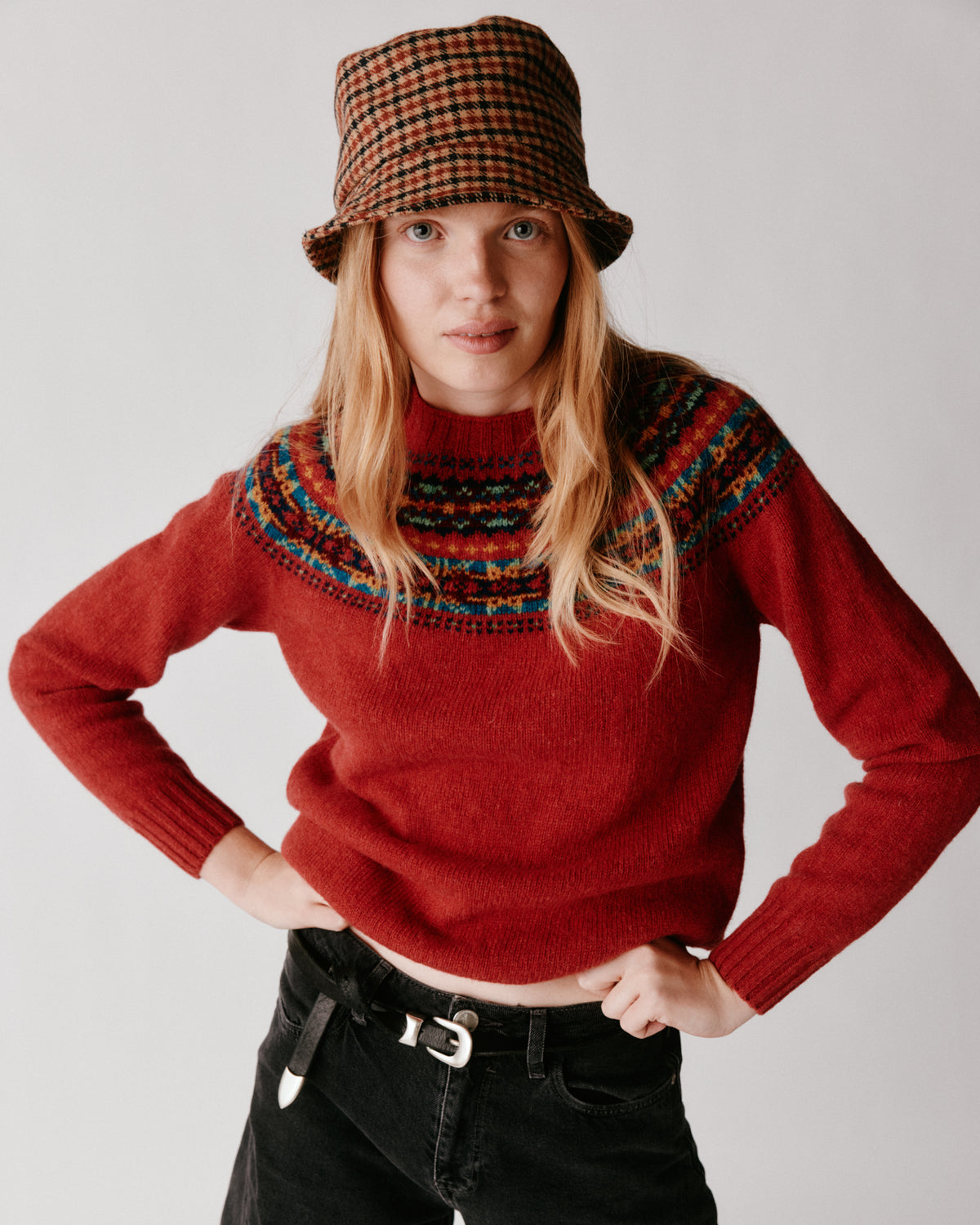 A model wearing a Bosie Skye Yoke Fair Isle Women's Sweater in colour Framboise.