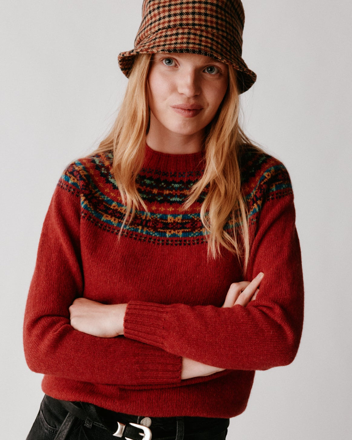 A model wearing a Bosie Skye Yoke Fair Isle Women's Sweater in colour Framboise.