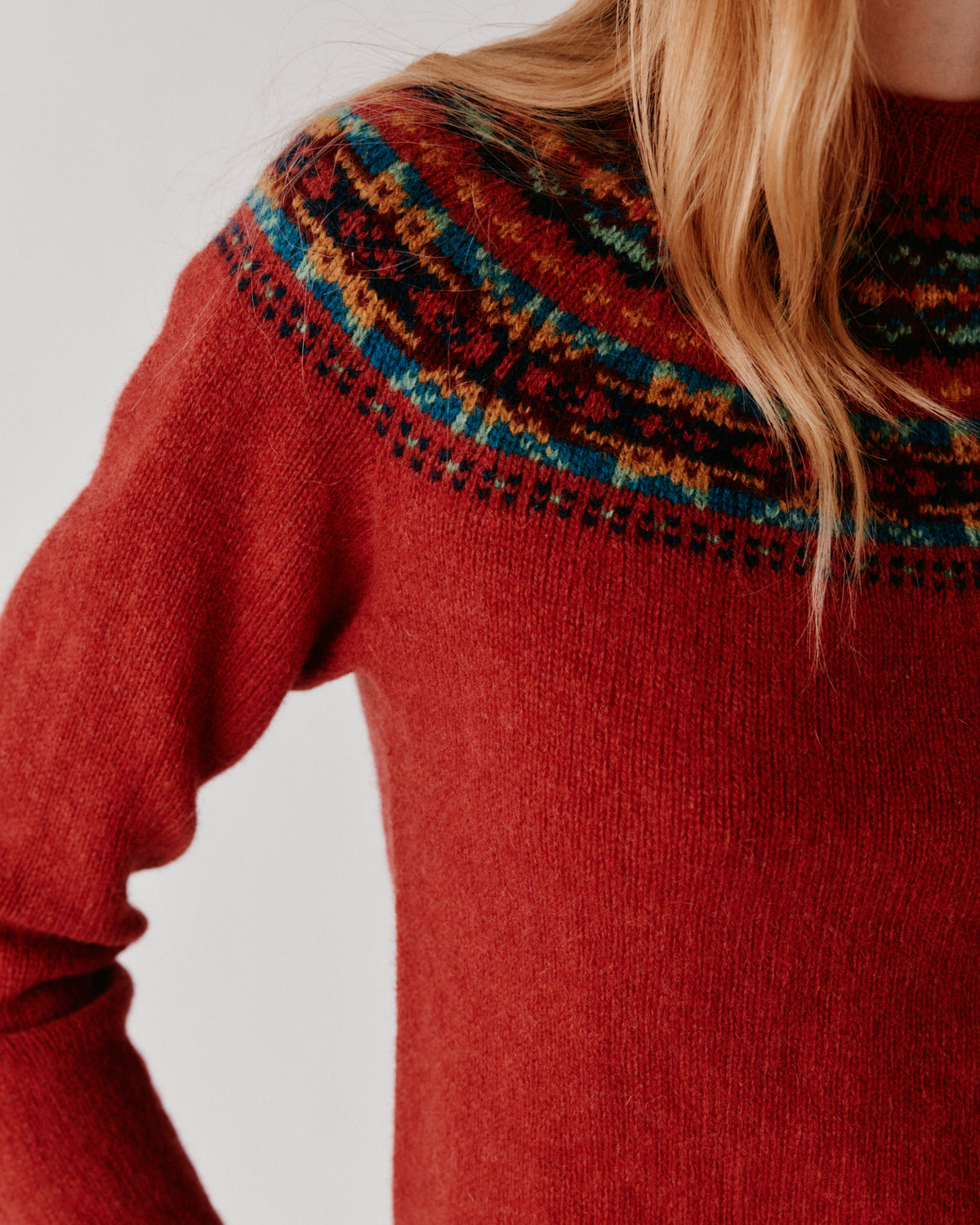 A model wearing a Bosie Skye Yoke Fair Isle Women's Sweater in colour Framboise.