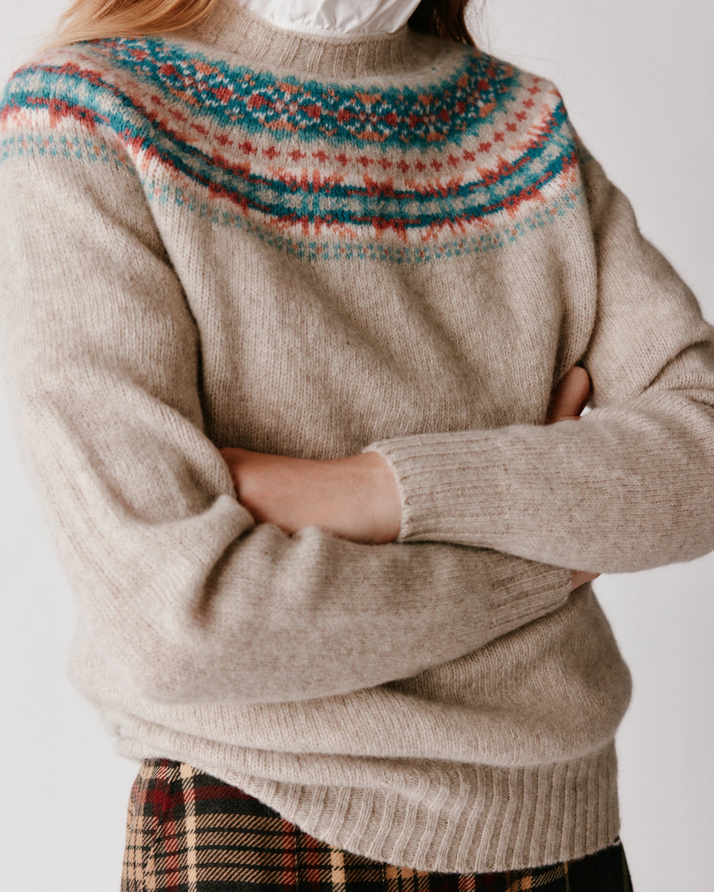 A model wearing a Bosie Skye Yoke Fair Isle Women's Sweater in colour Vellum / Putty.