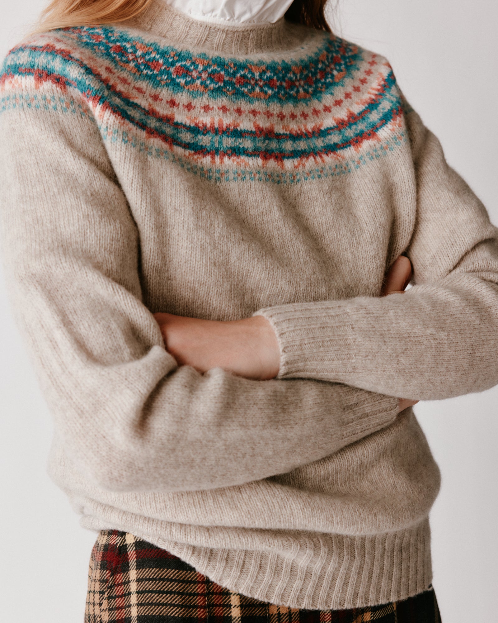 A model wearing a Bosie Skye Yoke Fair Isle Women's Sweater in colour Vellum / Putty.