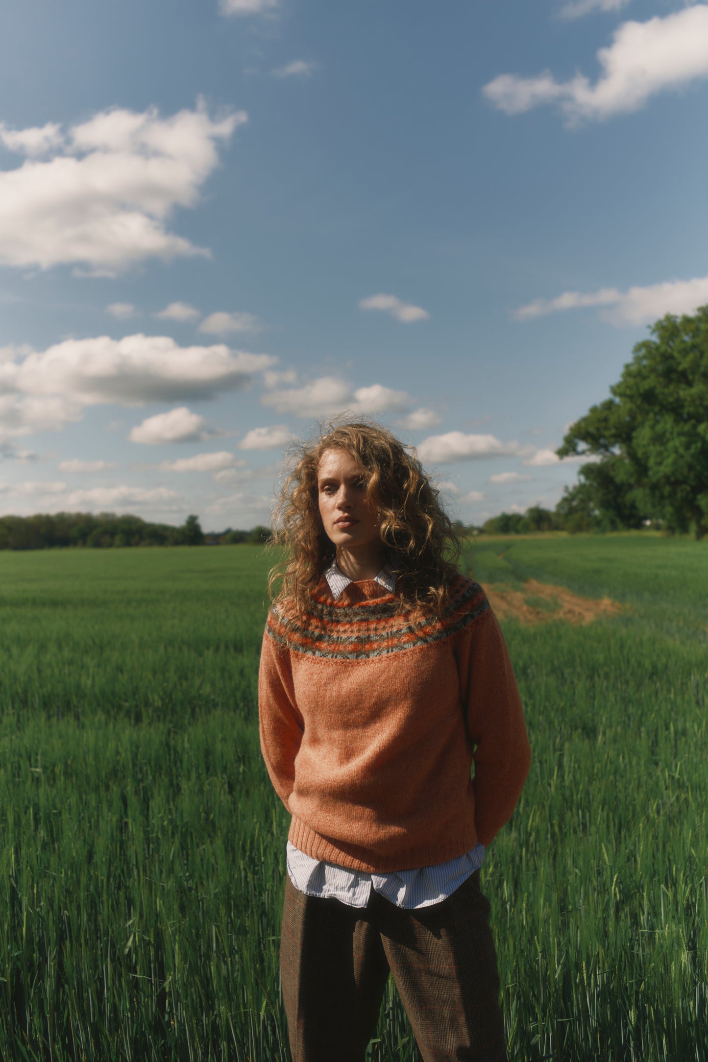 Model wearing a Skye Yoke Fair Isle Women's Sweater  in colour Parfait Peach. 