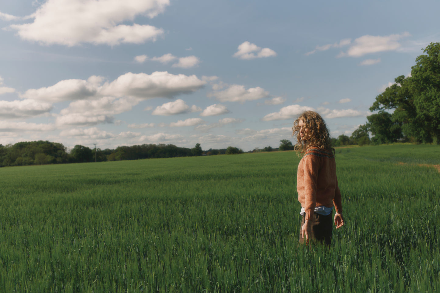 Model wearing a Skye Yoke Fair Isle Women's Sweater  in colour Parfait Peach. 
