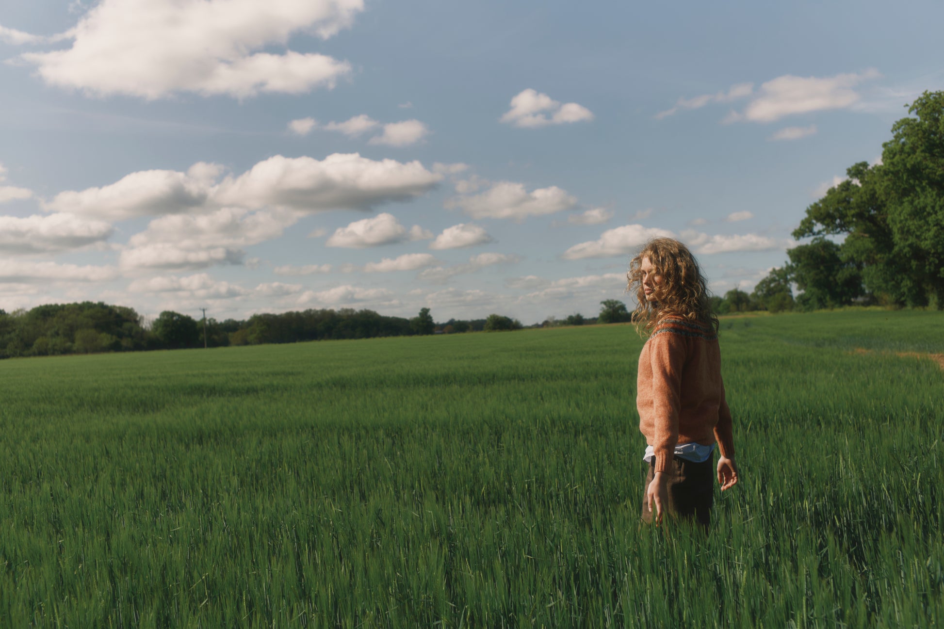 Model wearing a Skye Yoke Fair Isle Women's Sweater  in colour Parfait Peach. 