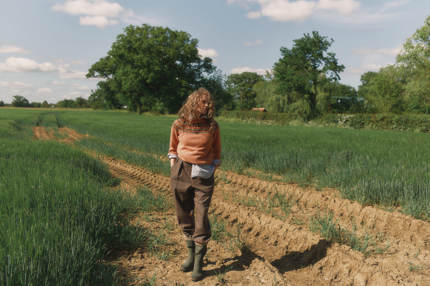 Model wearing a Skye Yoke Fair Isle Women's Sweater  in colour Parfait Peach. 