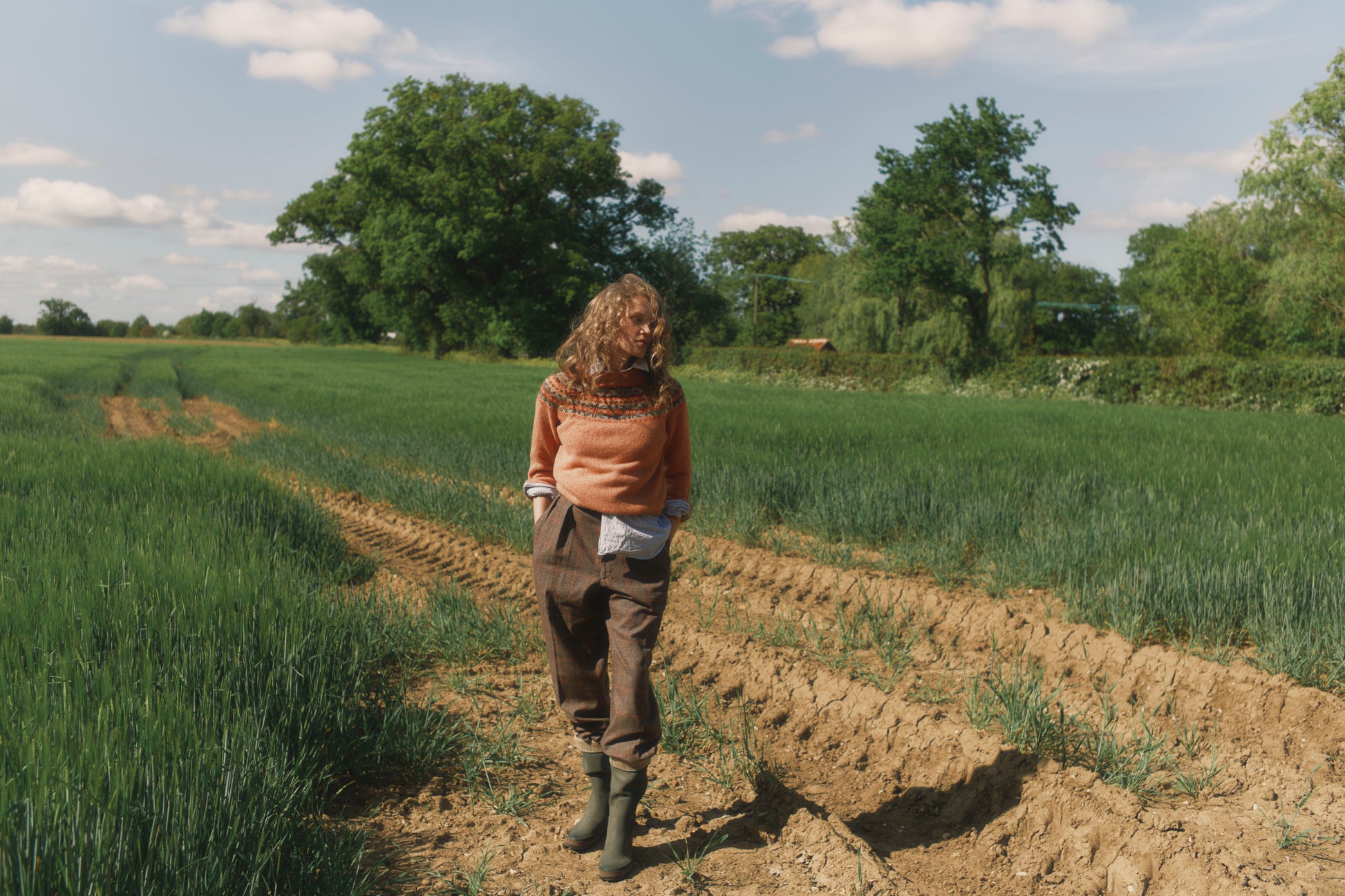 Model wearing a Skye Yoke Fair Isle Women's Sweater  in colour Parfait Peach. 