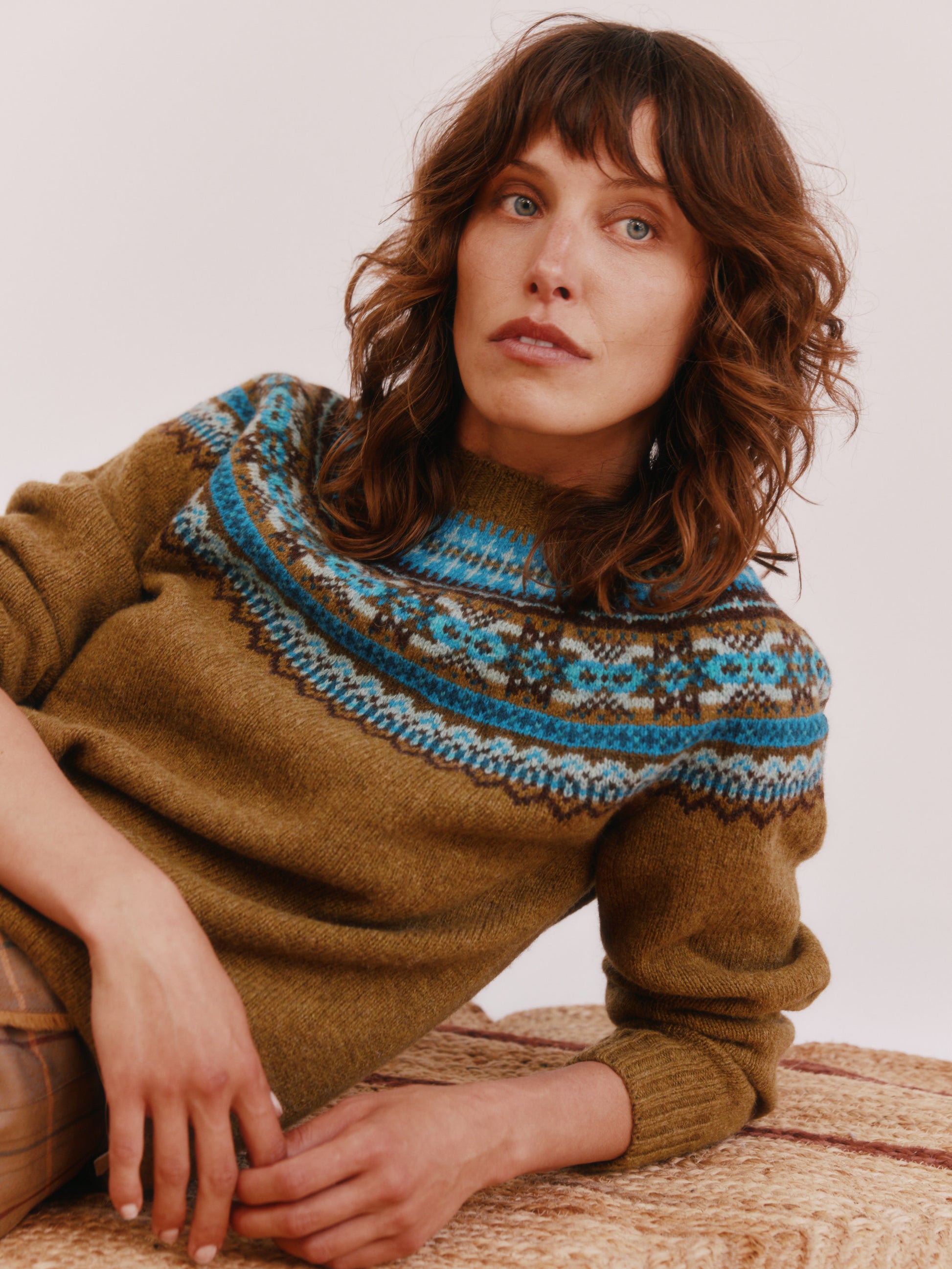 Model wearing a Bosie Knitwear Sorcha Yoke Fair Isle Women's Sweater in colour Asparagus Brown.