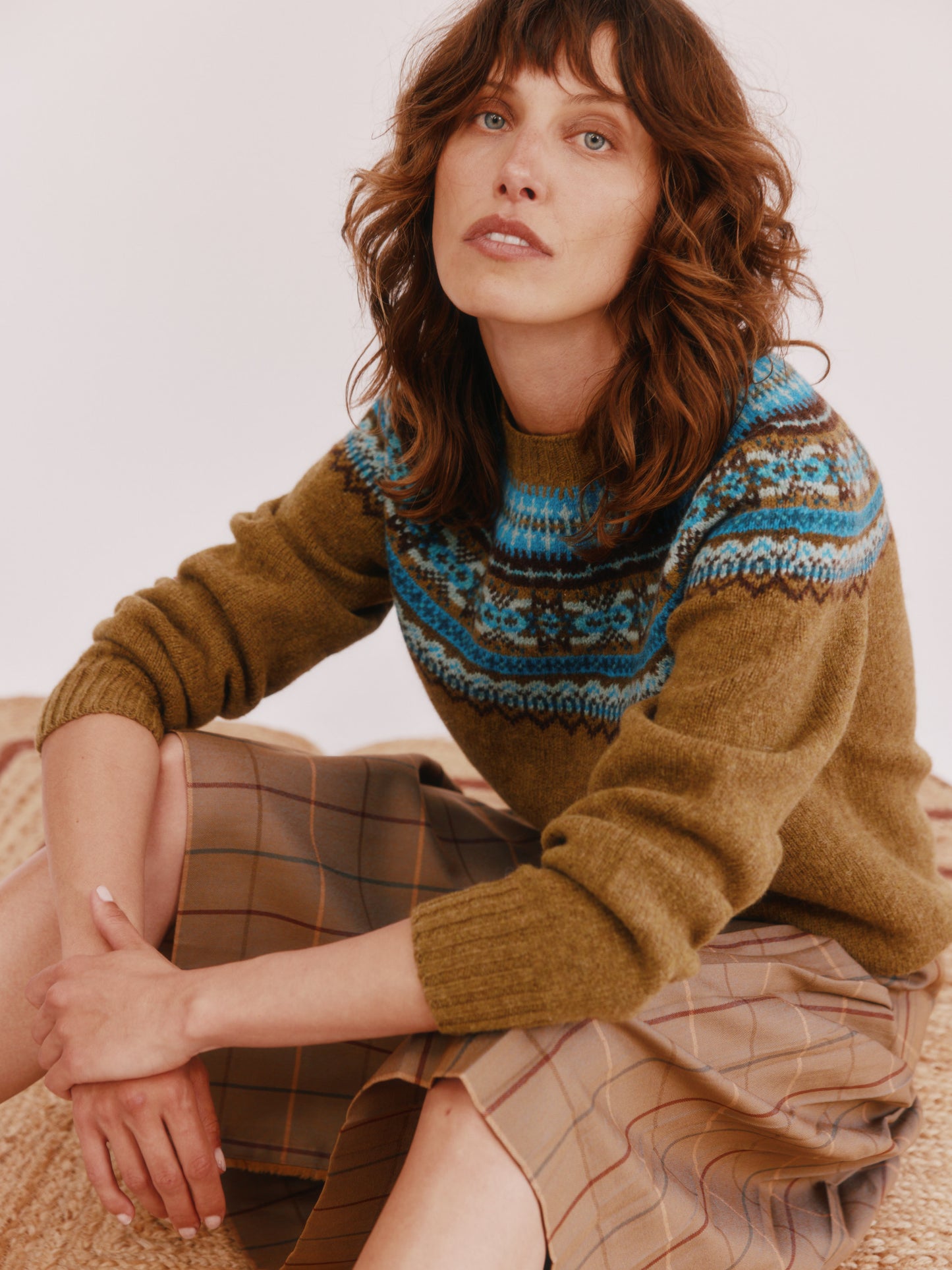 Model wearing a Bosie Knitwear Sorcha Yoke Fair Isle Women's Sweater in colour Asparagus Brown.