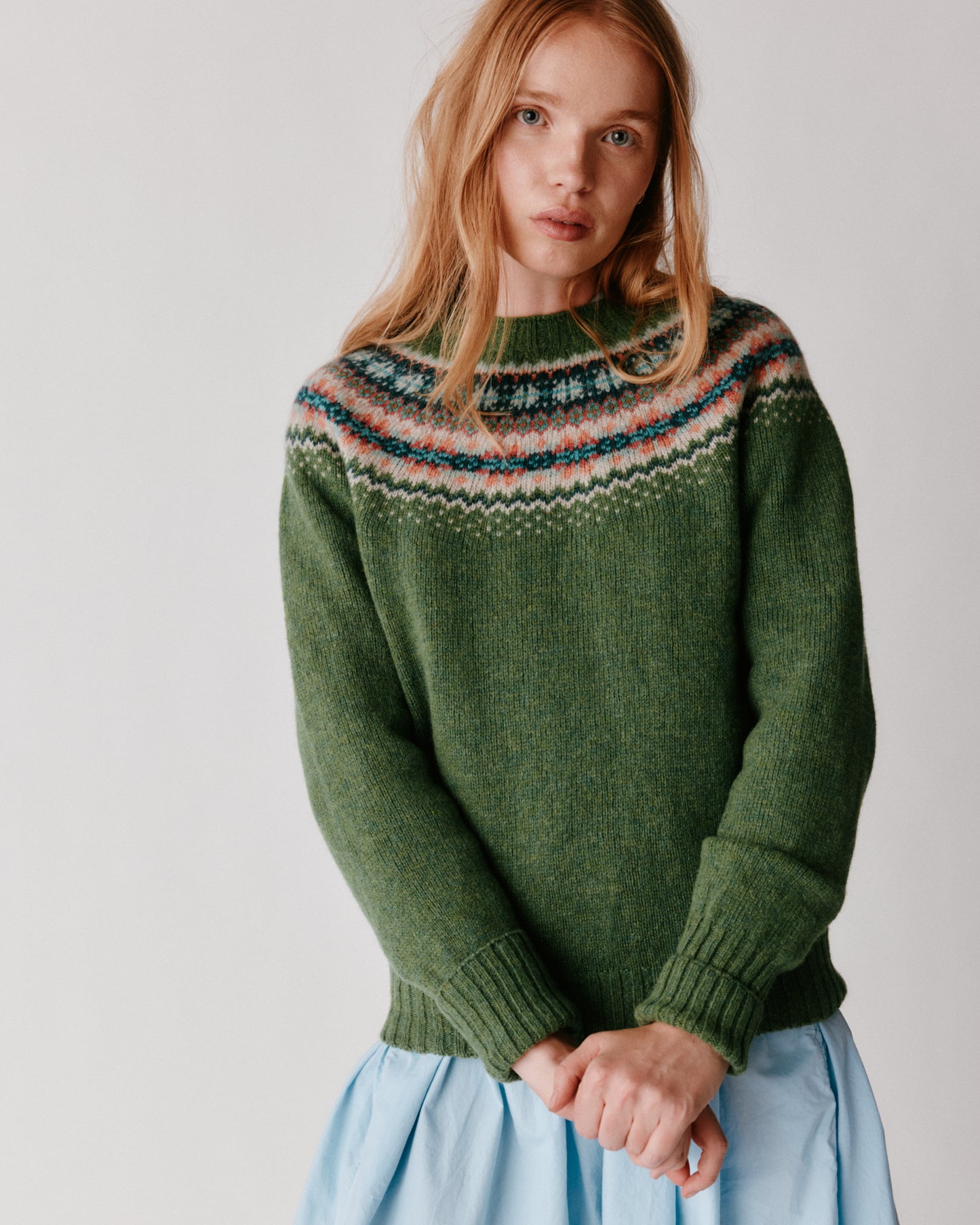 A model wearing a Bosie West Coast Yoke Fair Isle Women's Sweater in colour Baize.