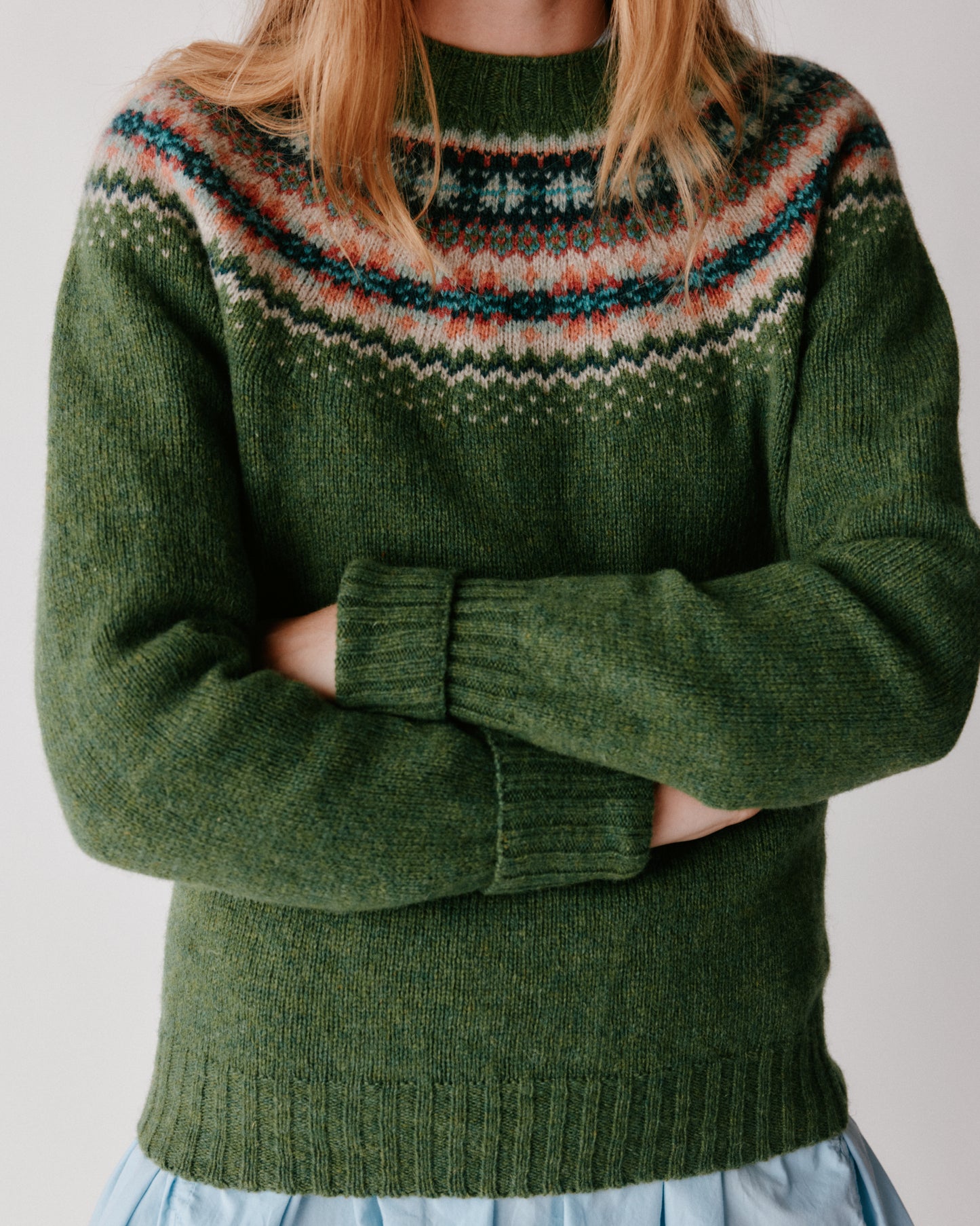 A model wearing a Bosie West Coast Yoke Fair Isle Women's Sweater in colour Baize.