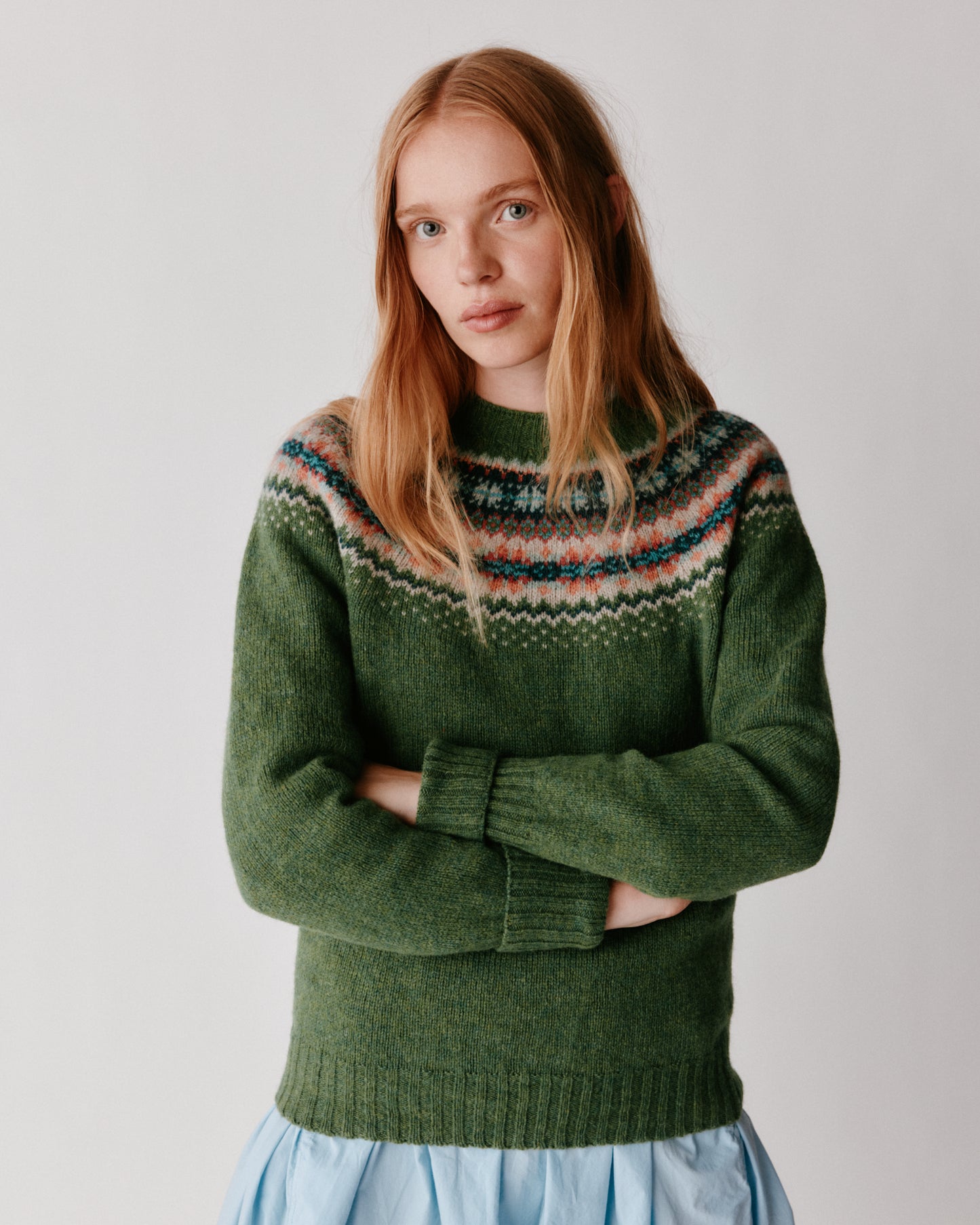 A model wearing a West Coast Yoke Fair Isle Women's Sweater in colour Baize.