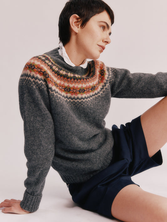 Model wearing a Bosie Knitwear West Coast Yoke Fair Isle Women's Sweater in colour Oxford Grey.