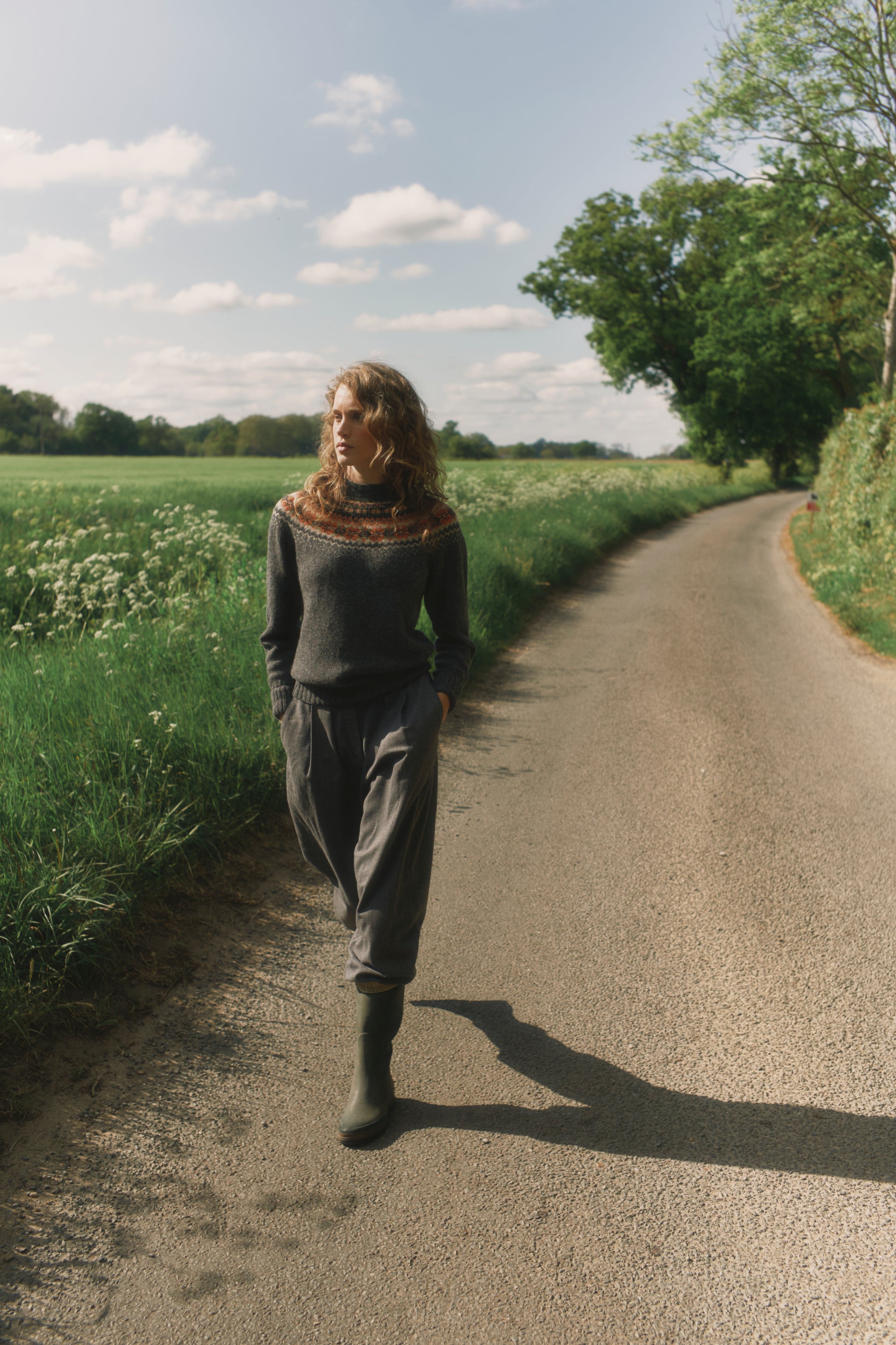 Model wearing a Bosie Knitwear West Coast Yoke Fair Isle Women's Sweater in colour Oxford Grey.