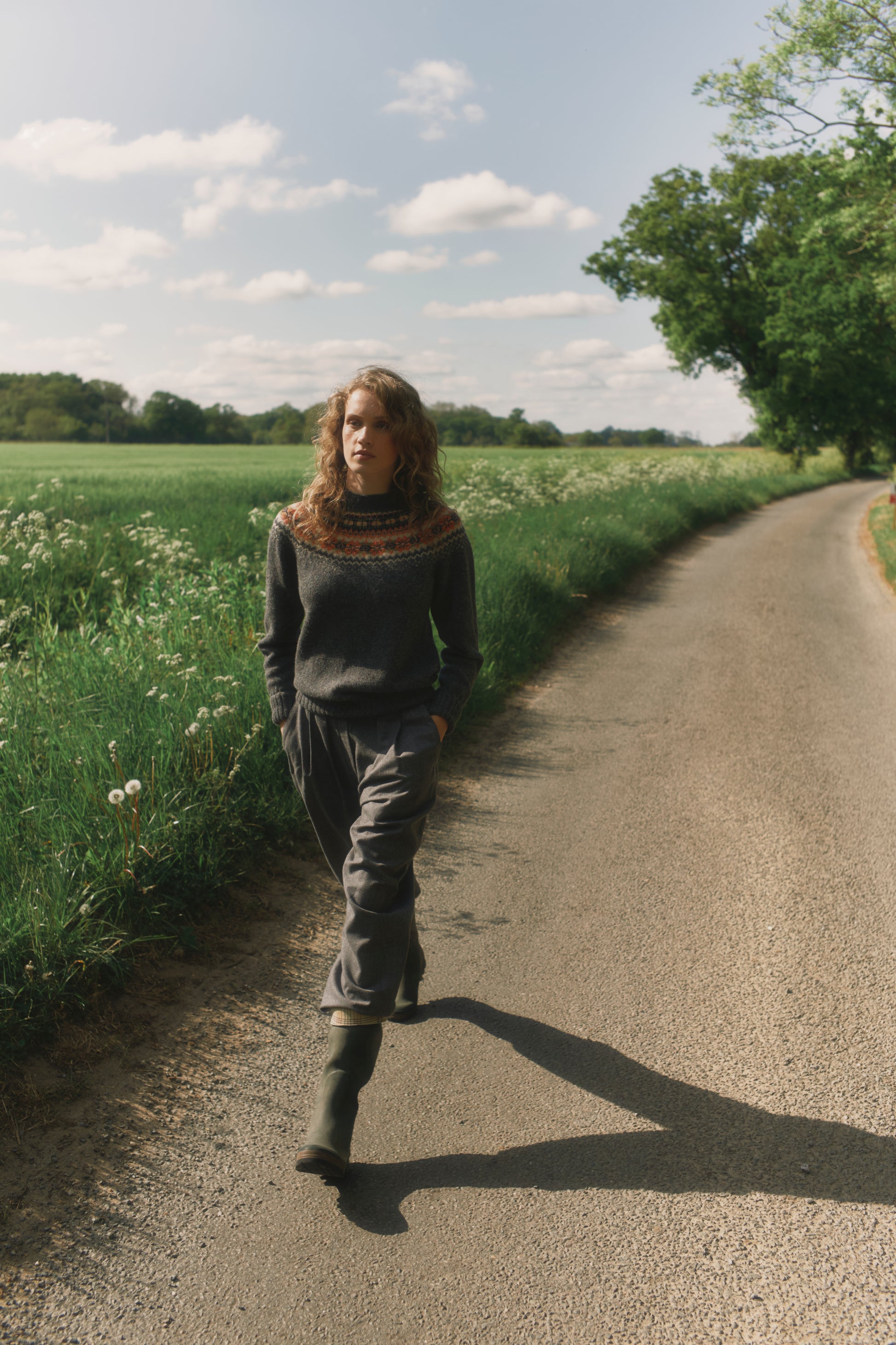 Model wearing a Bosie Knitwear West Coast Yoke Fair Isle Women's Sweater in colour Oxford Grey.