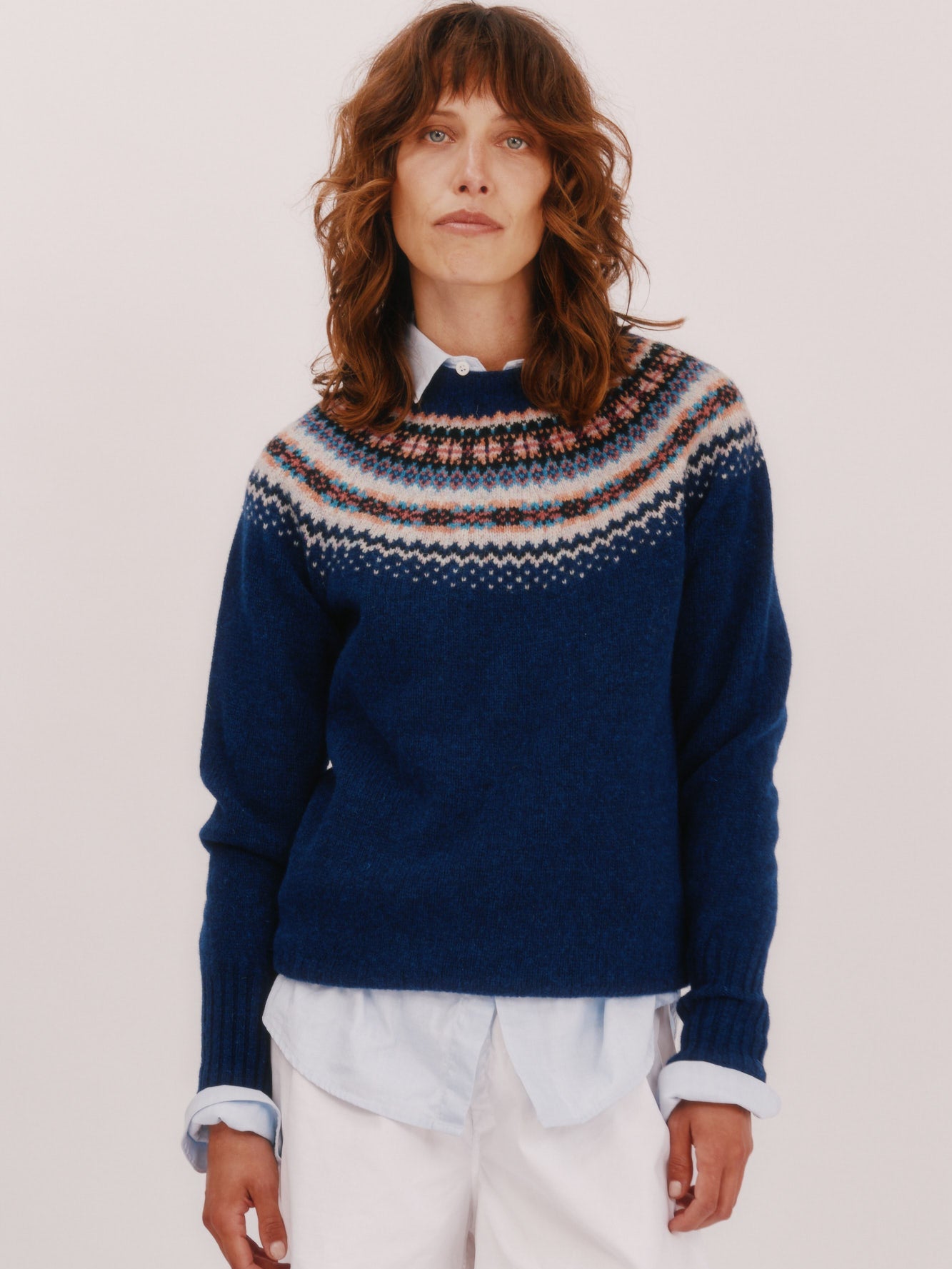 Model wearing a Bosie Knitwear West Coast Yoke Fair Isle Women's Sweater in colour Starnight Blue. Navy