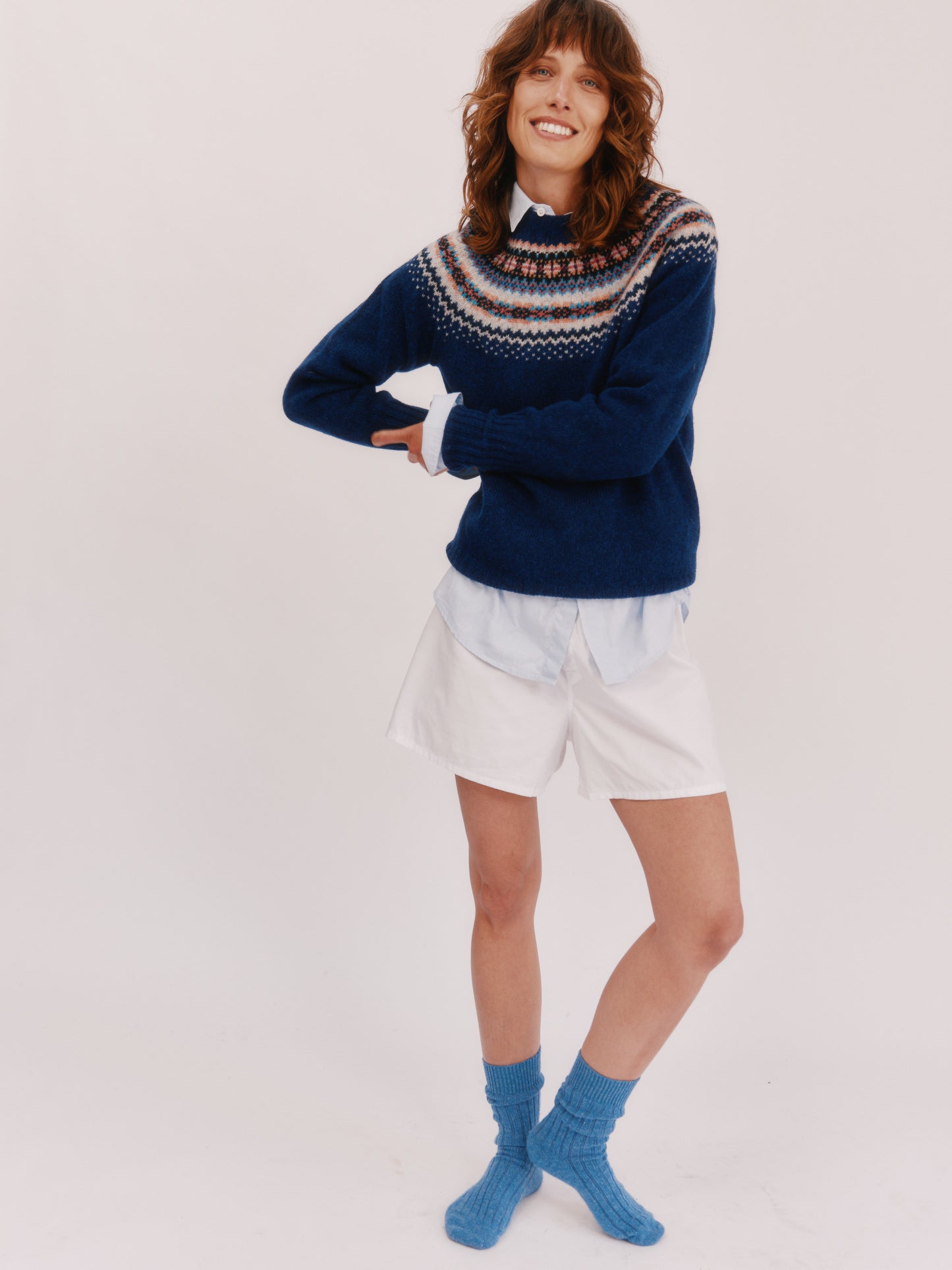 Model wearing a Bosie Knitwear West Coast Yoke Fair Isle Women's Sweater in colour Starnight Blue. 