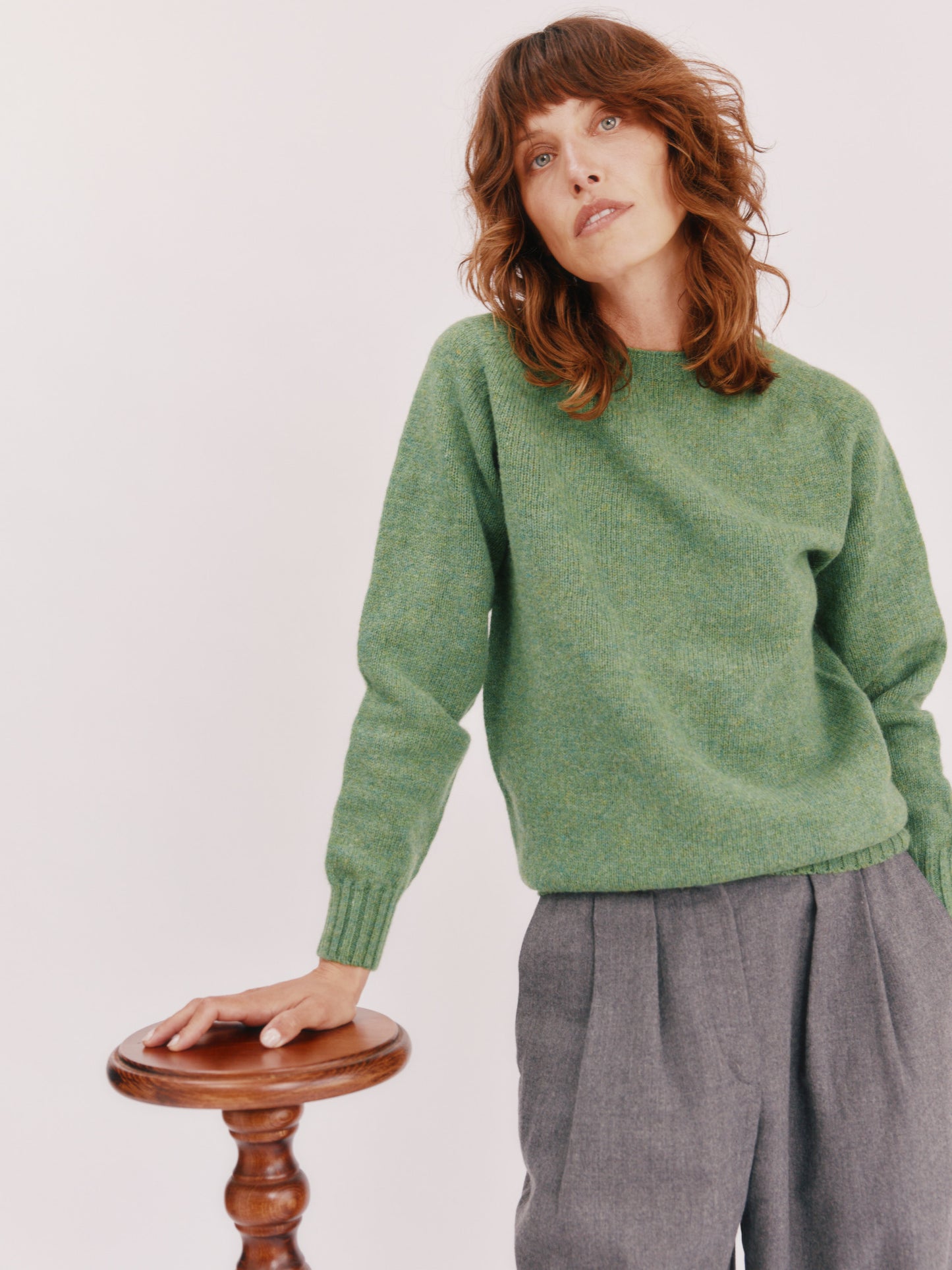 Model wearing a womens harley of scotland seamless saddle shoulder shetland sweater in colour Baize Green from Bosie Knitwear. 