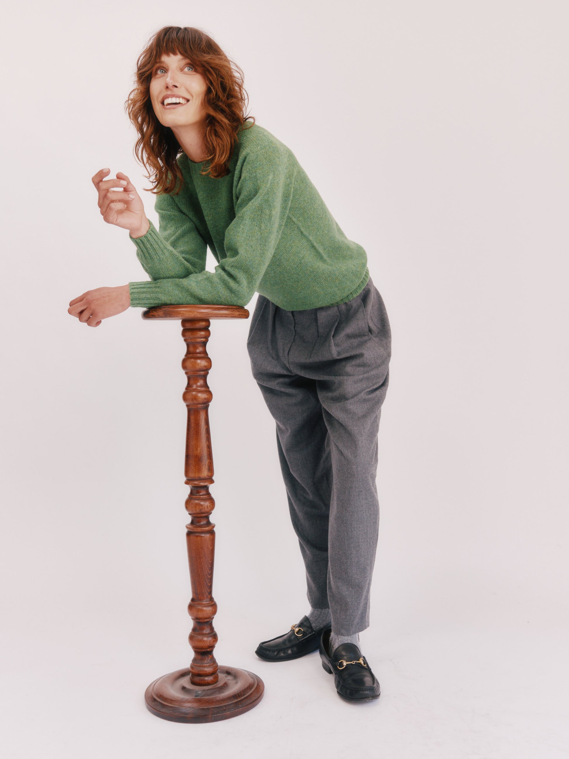 Model wearing a womens harley of scotland seamless saddle shoulder shetland sweater in colour Baize Green from Bosie Knitwear. 