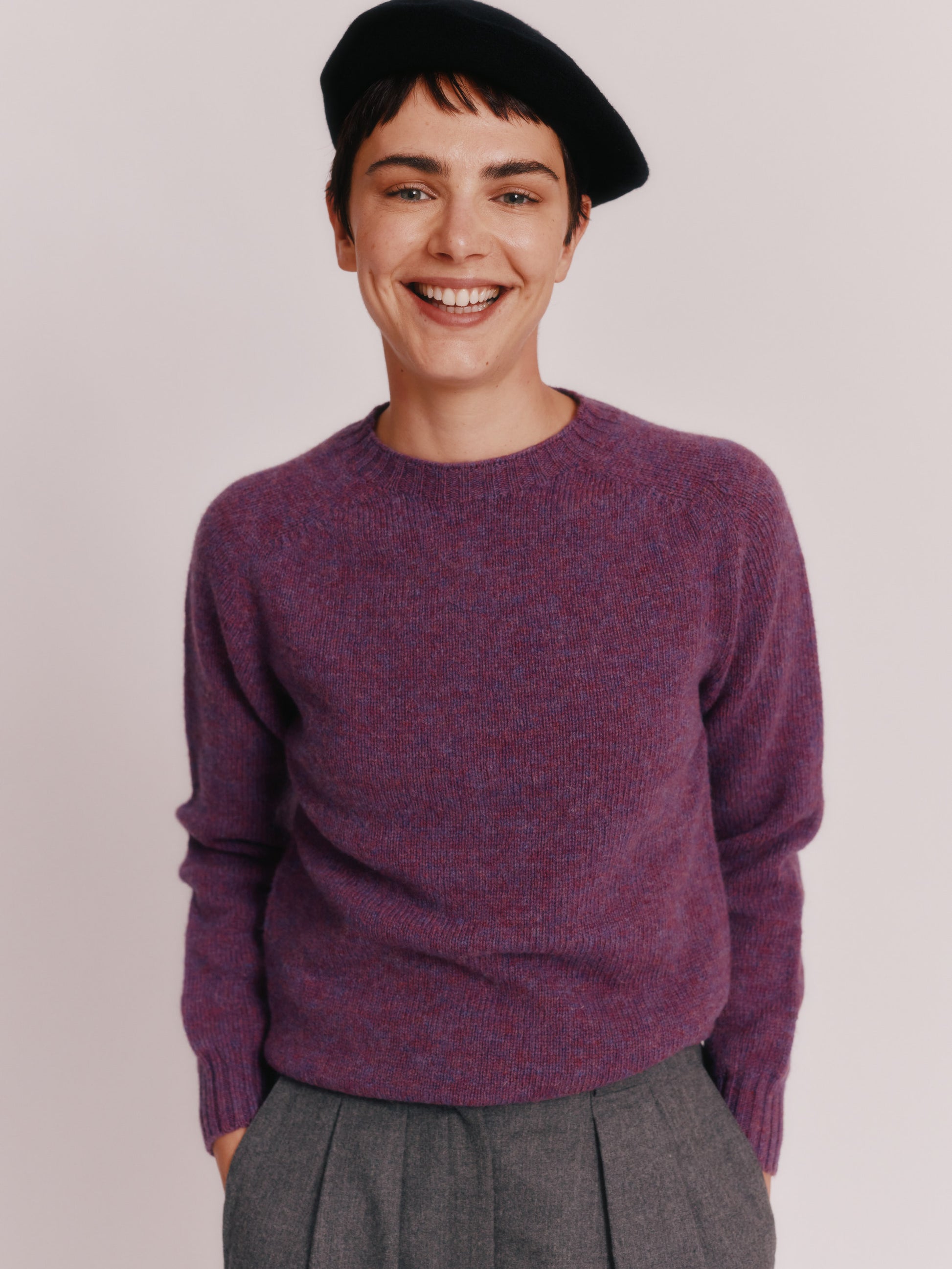 Model wearing a Womens Harley of Scotland Seamless Saddle Shoulder Shetland Sweater  in colour Calluna Purple.