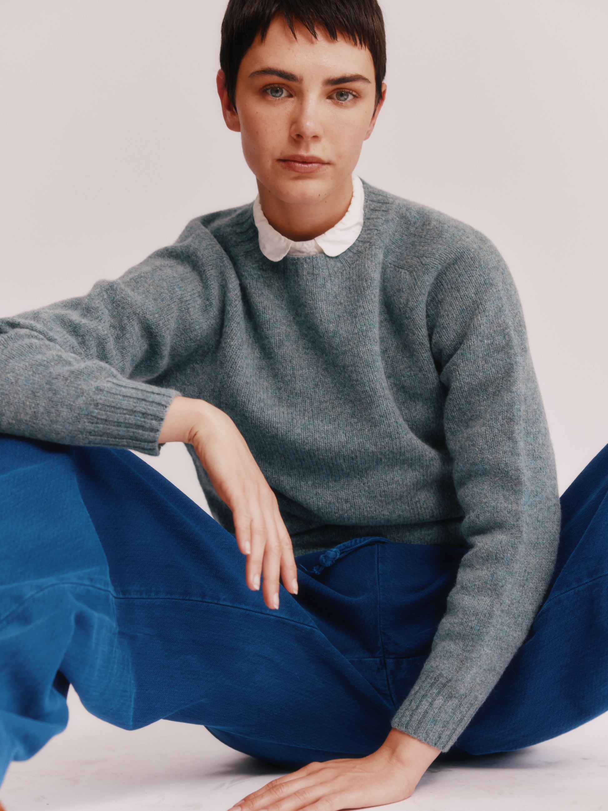 Model wearing a Bosie Knitwear Womens Harley of Scotland Seamless Saddle Shoulder Shetland Sweater in colour Graphite Green.