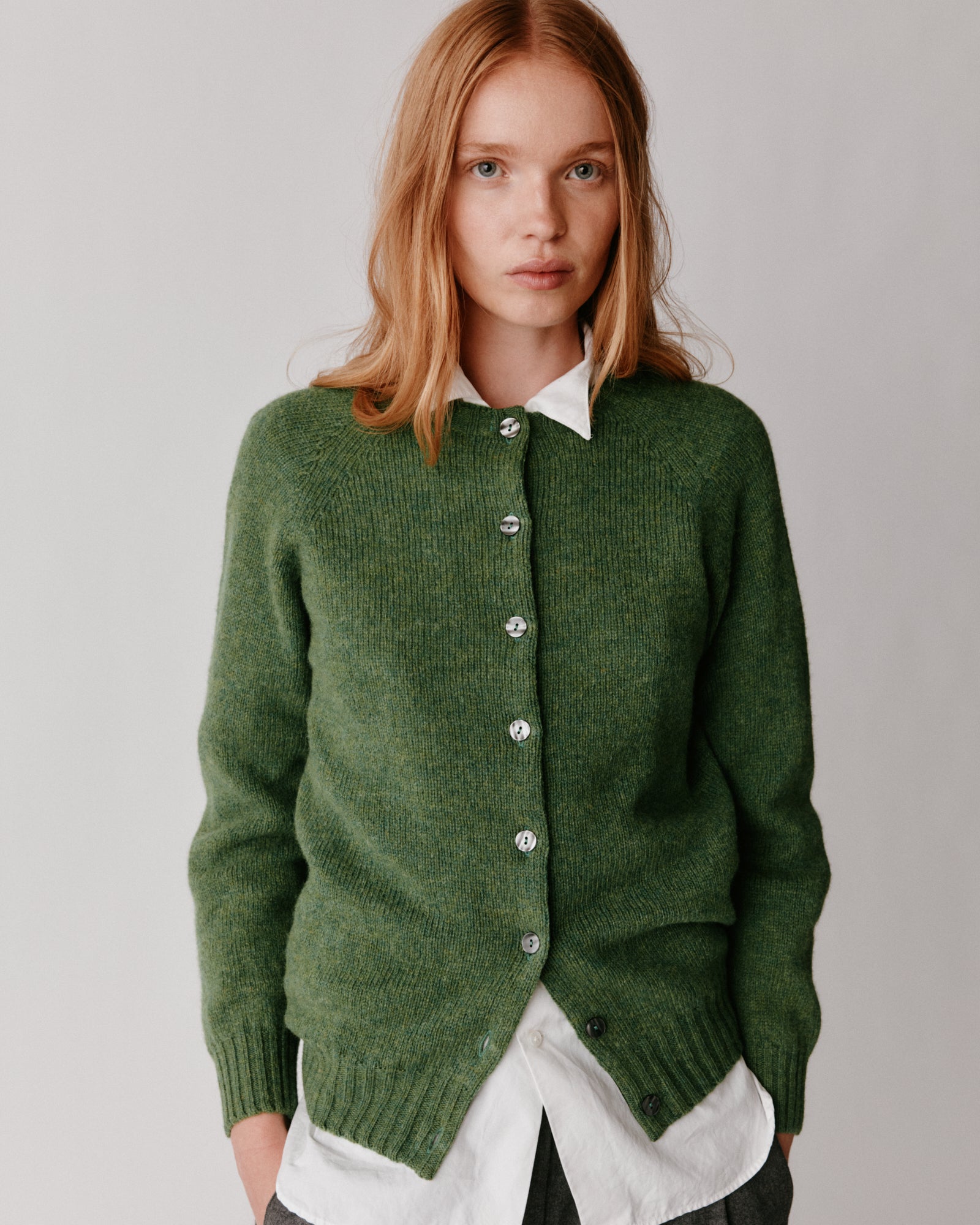 A model wearing a Bosie Womens Harley of Scotland Shetland Crew Neck Cardigan in colour Baize.