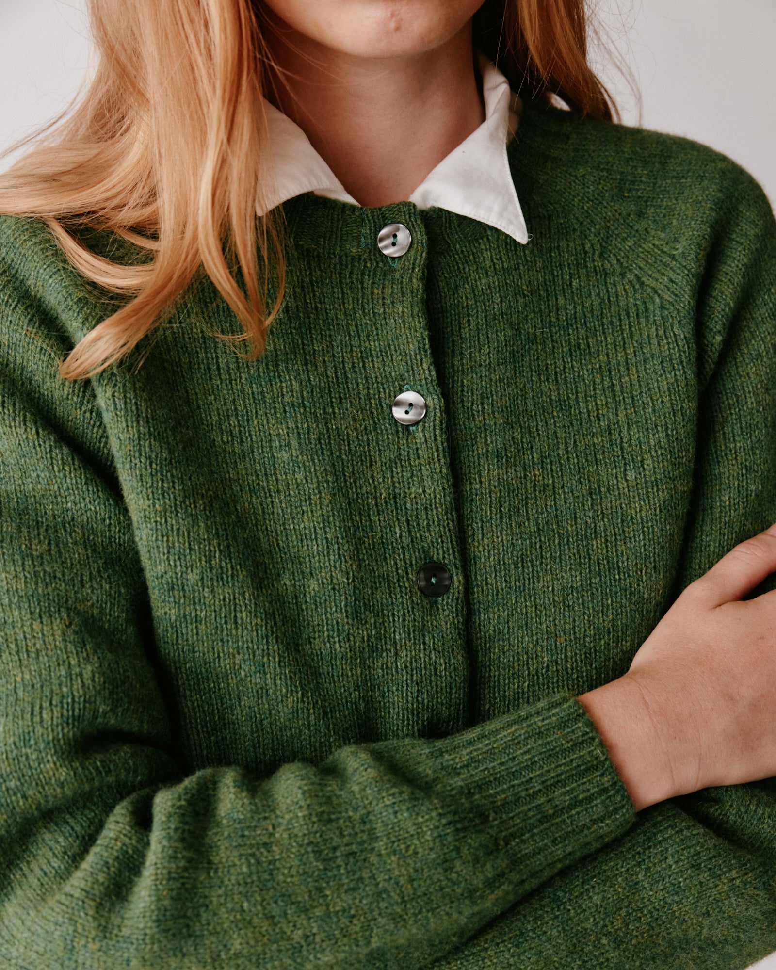 A model wearing a Bosie Womens Harley of Scotland Shetland Crew Neck Cardigan in colour Baize.