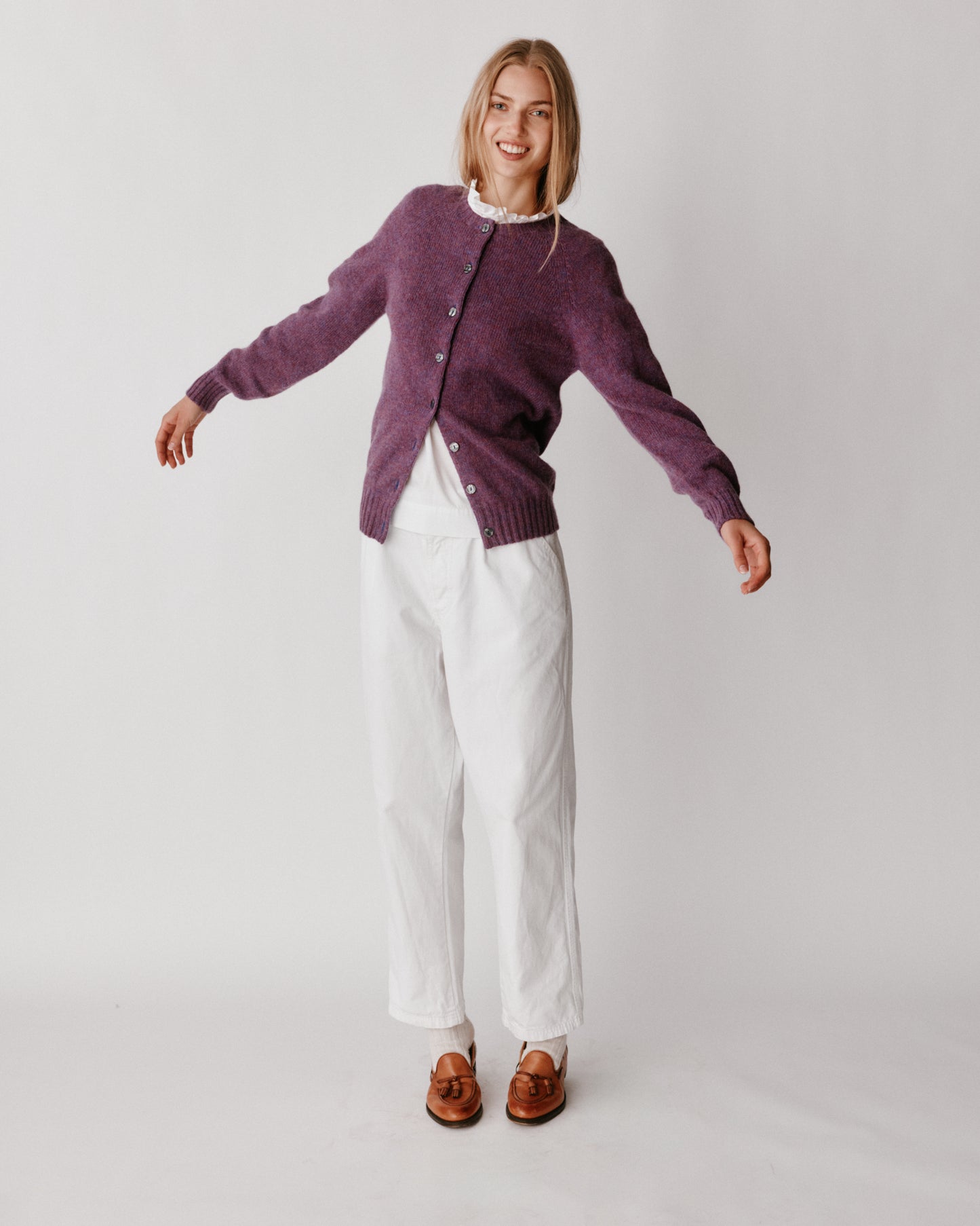 A model wearing a Bosie Womens Harley of Scotland Shetland Crew Neck Cardigan in colour Calluna.