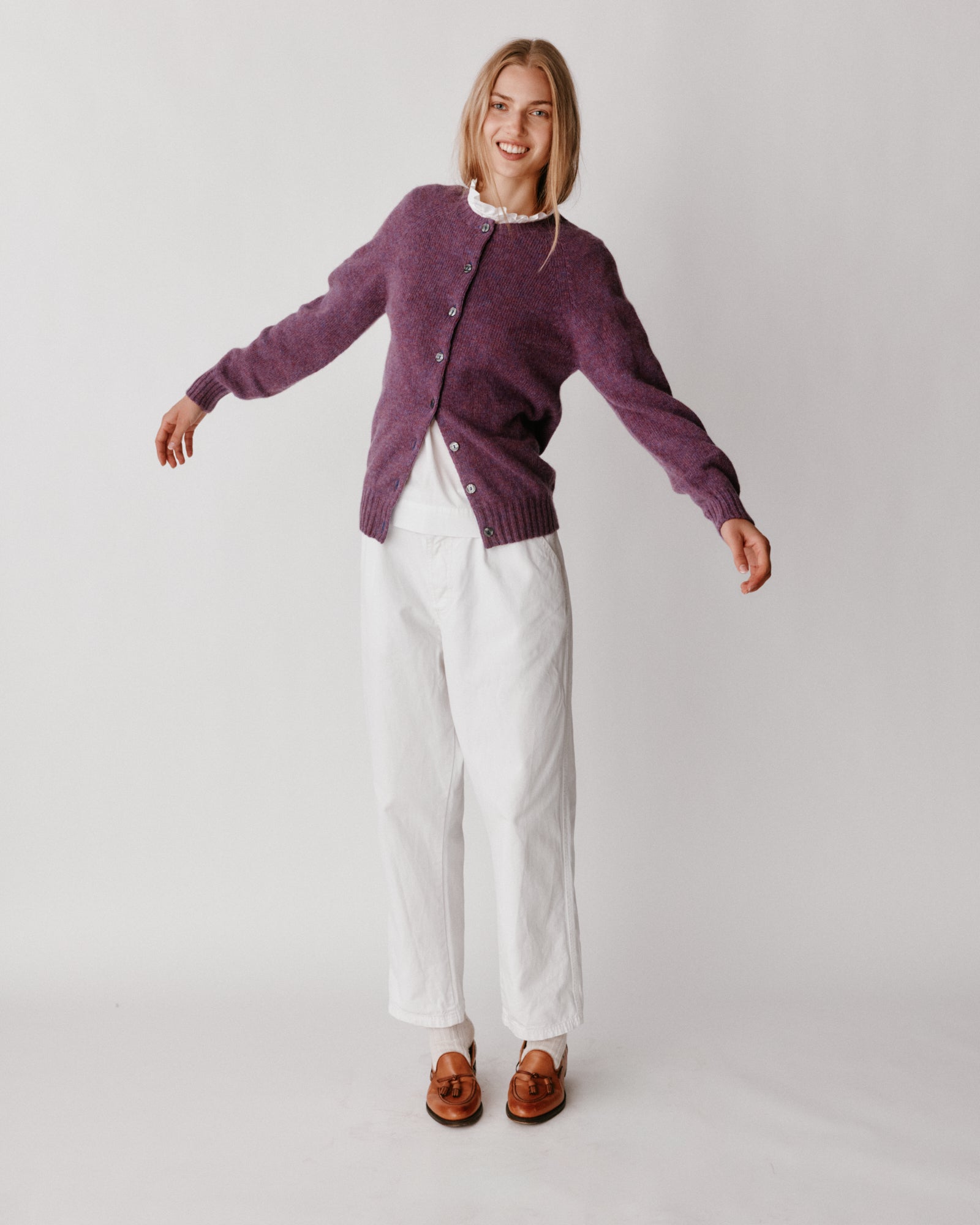 A model wearing a Bosie Womens Harley of Scotland Shetland Crew Neck Cardigan in colour Calluna.