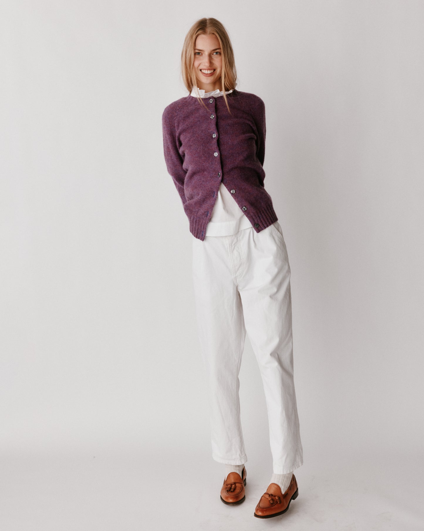 A model wearing a Bosie Womens Harley of Scotland Shetland Crew Neck Cardigan in colour Calluna.