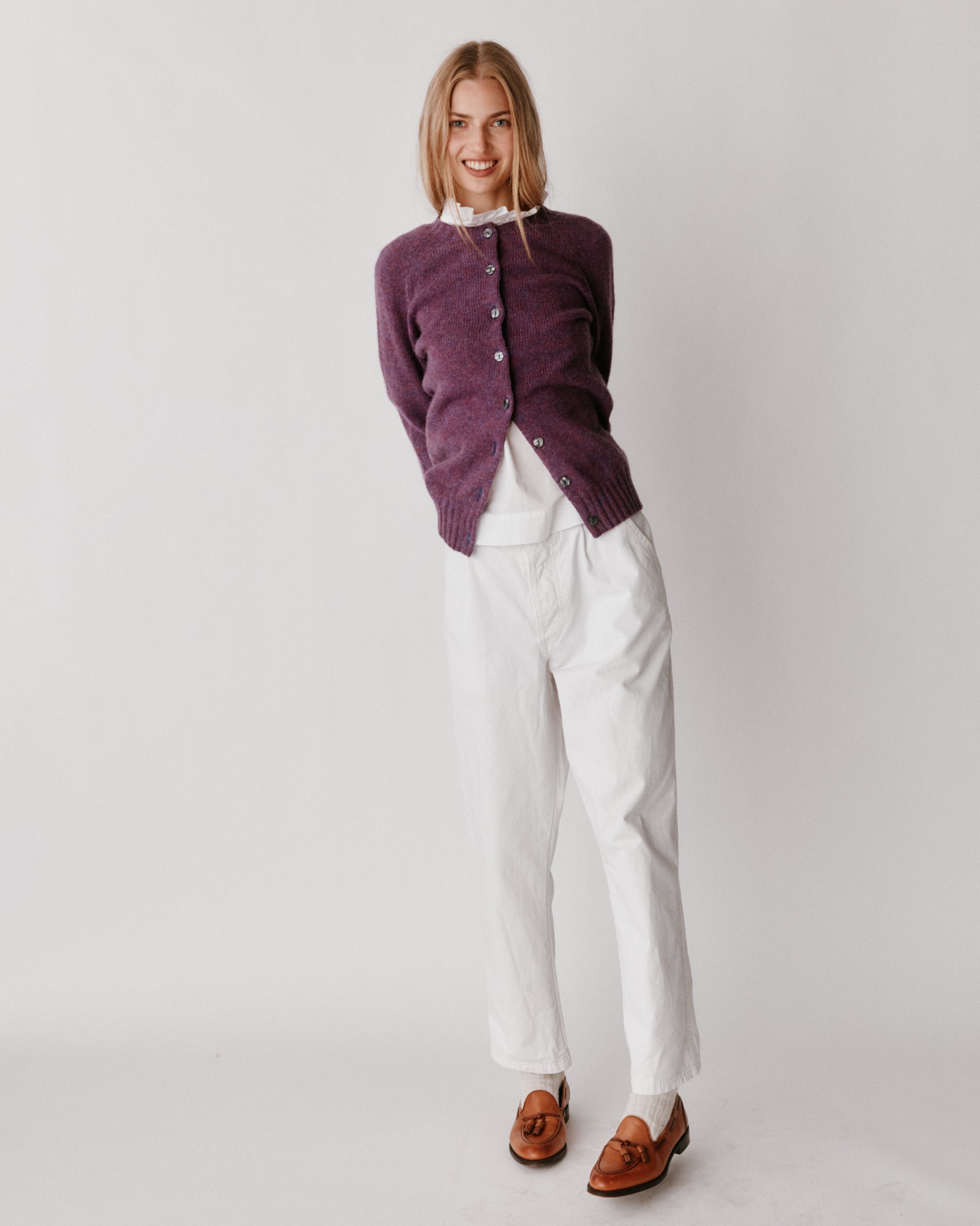A model wearing a Bosie Womens Harley of Scotland Shetland Crew Neck Cardigan in colour Calluna.