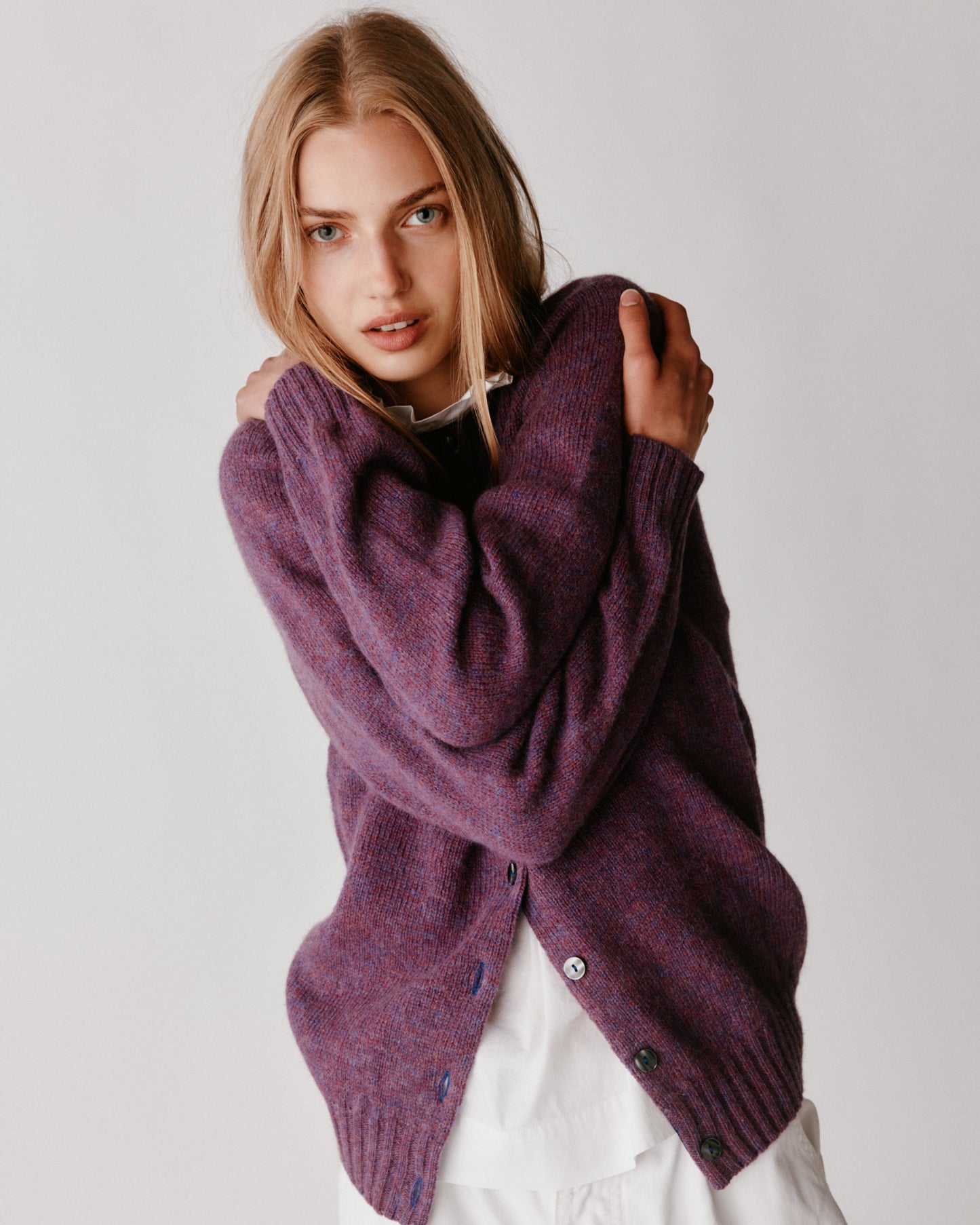 A model wearing a Bosie Womens Harley of Scotland Shetland Crew Neck Cardigan in colour Calluna.