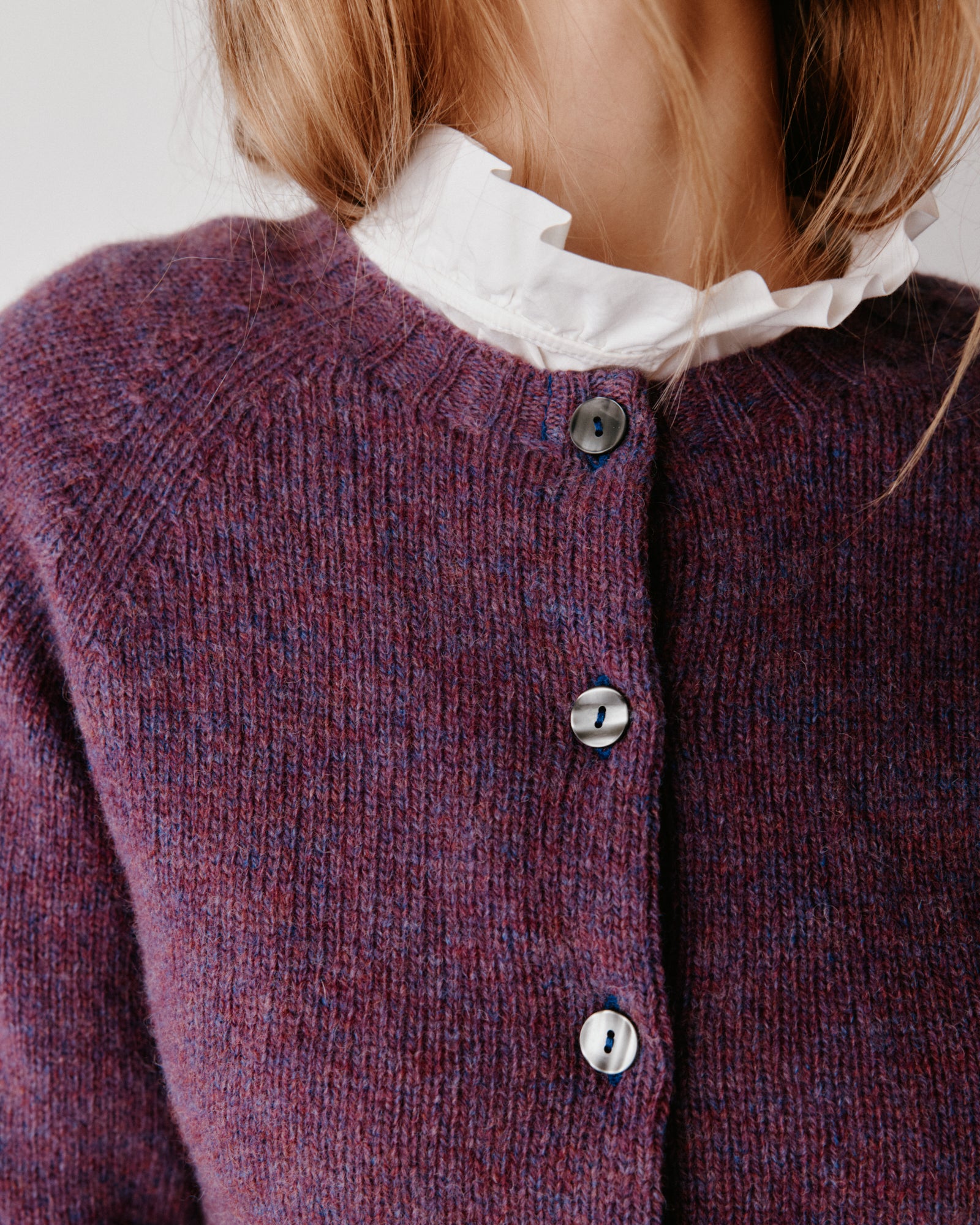 A model wearing a Bosie Womens Harley of Scotland Shetland Crew Neck Cardigan in colour Calluna.