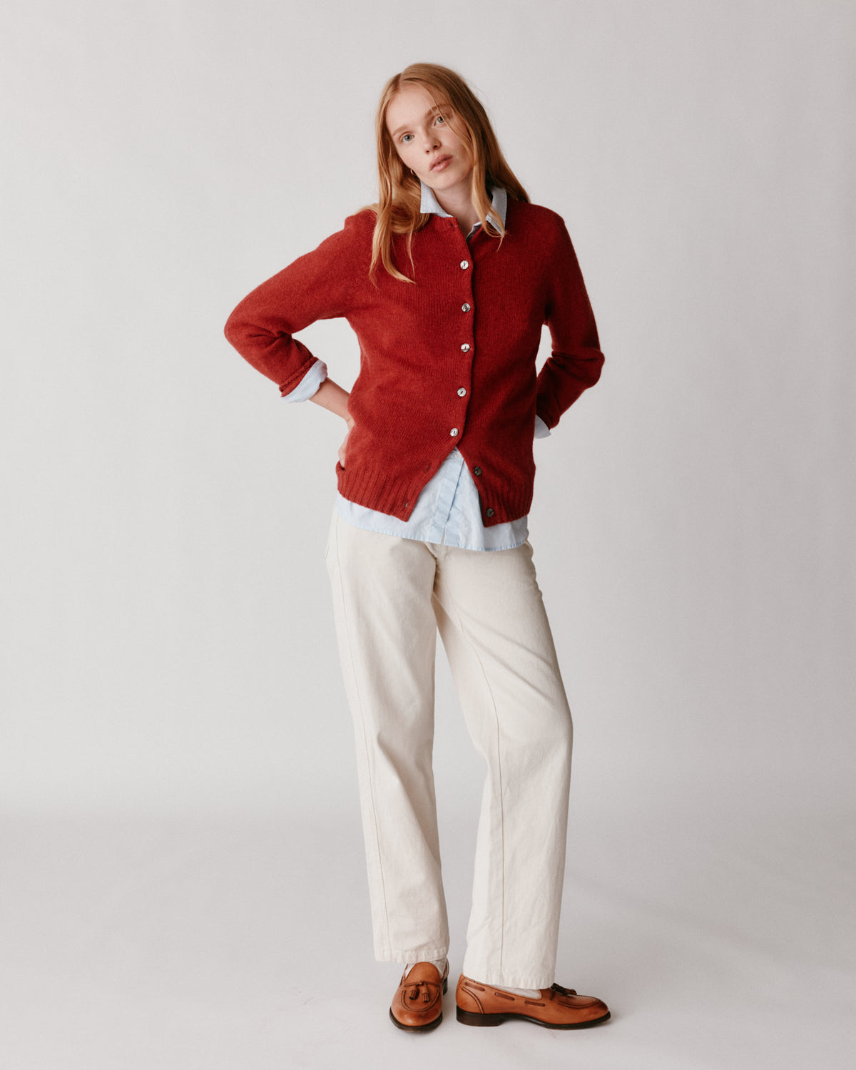 A model wearing a Bosie Womens Harley of Scotland Shetland Crew Neck Cardigan in colour Framboise.