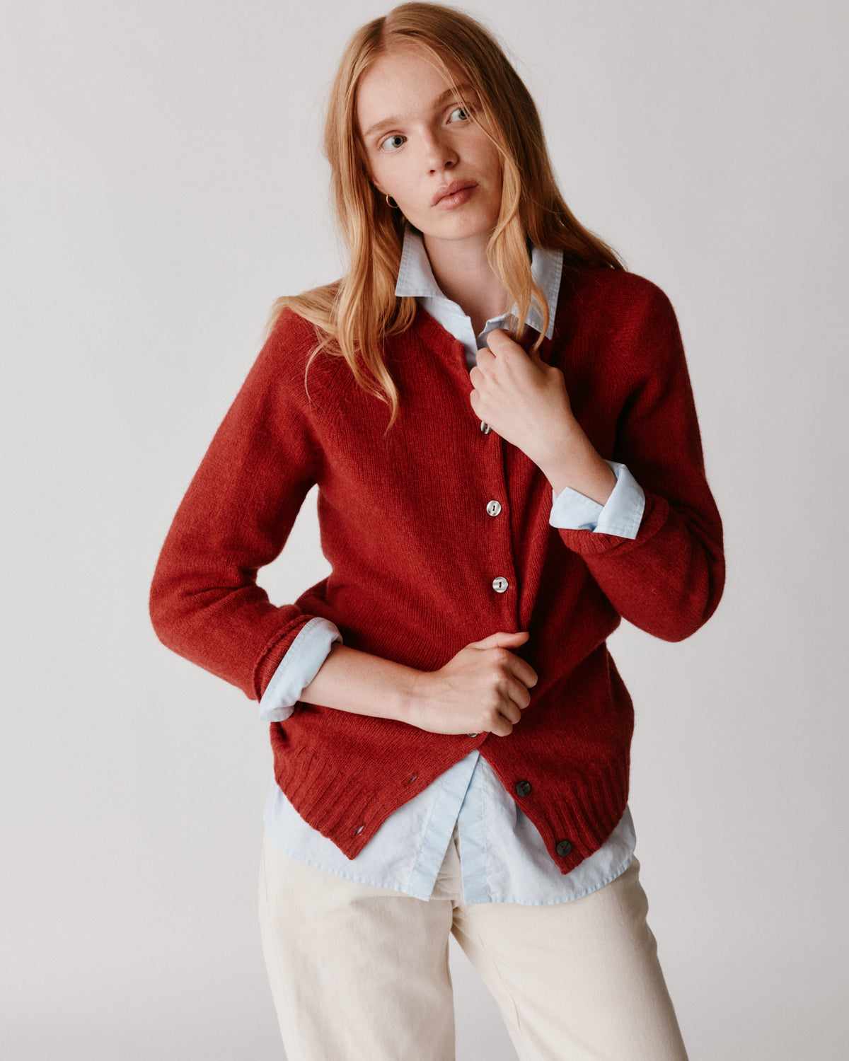 A model wearing a Bosie Womens Harley of Scotland Shetland Crew Neck Cardigan in colour Framboise