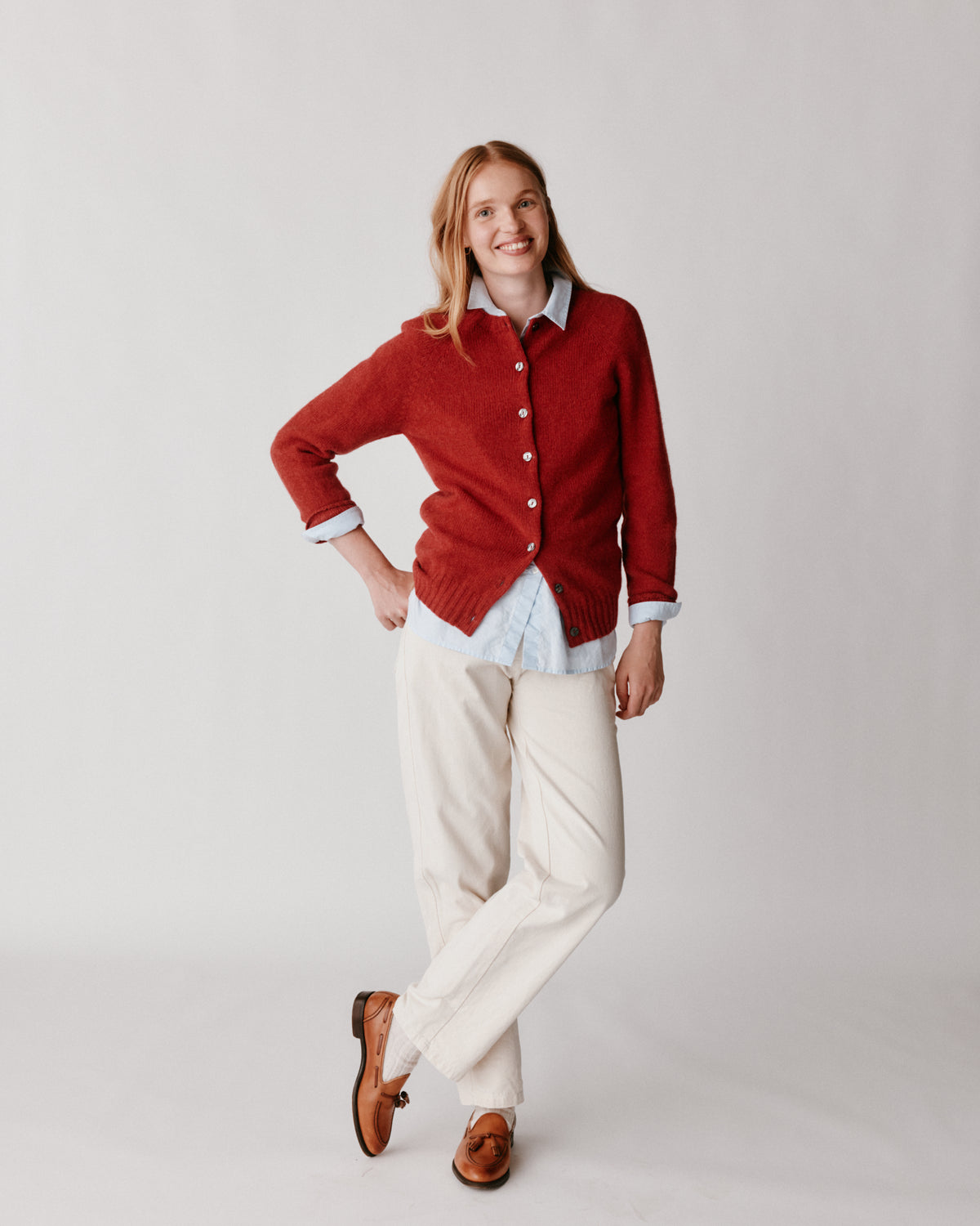 A model wearing a Bosie Womens Harley of Scotland Shetland Crew Neck Cardigan in colour Framboise.