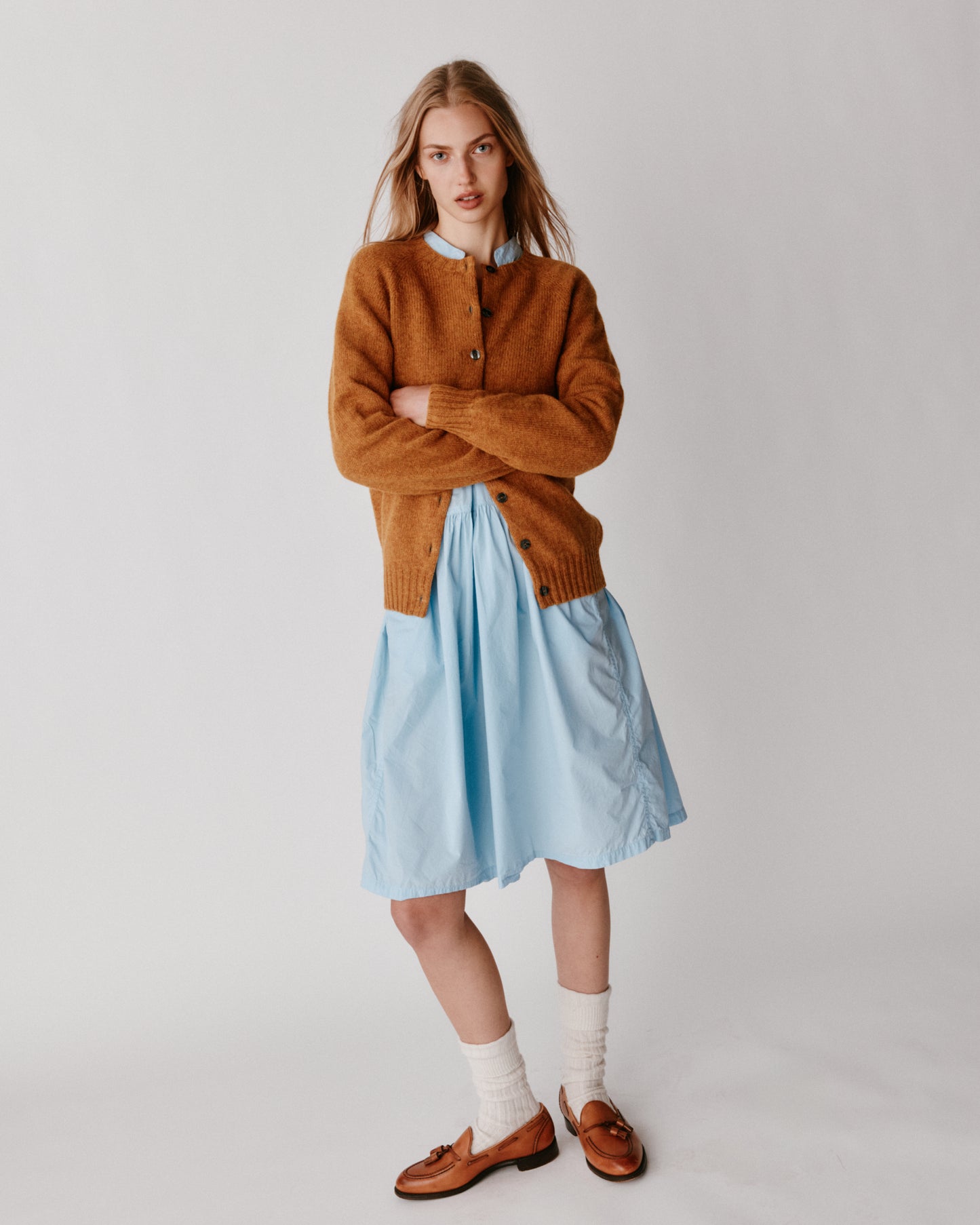 A model wearing a Bosie Womens Harley of Scotland Shetland Crew Neck Cardigan in colour Gold Dust / Cummin.