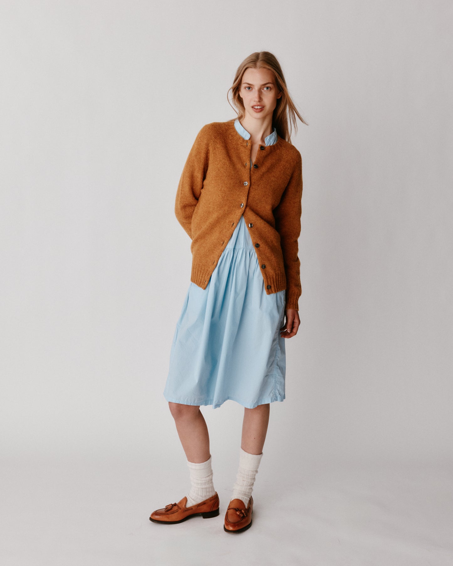 A model wearing a Bosie Womens Harley of Scotland Shetland Crew Neck Cardigan in colour Gold Dust / Cummin