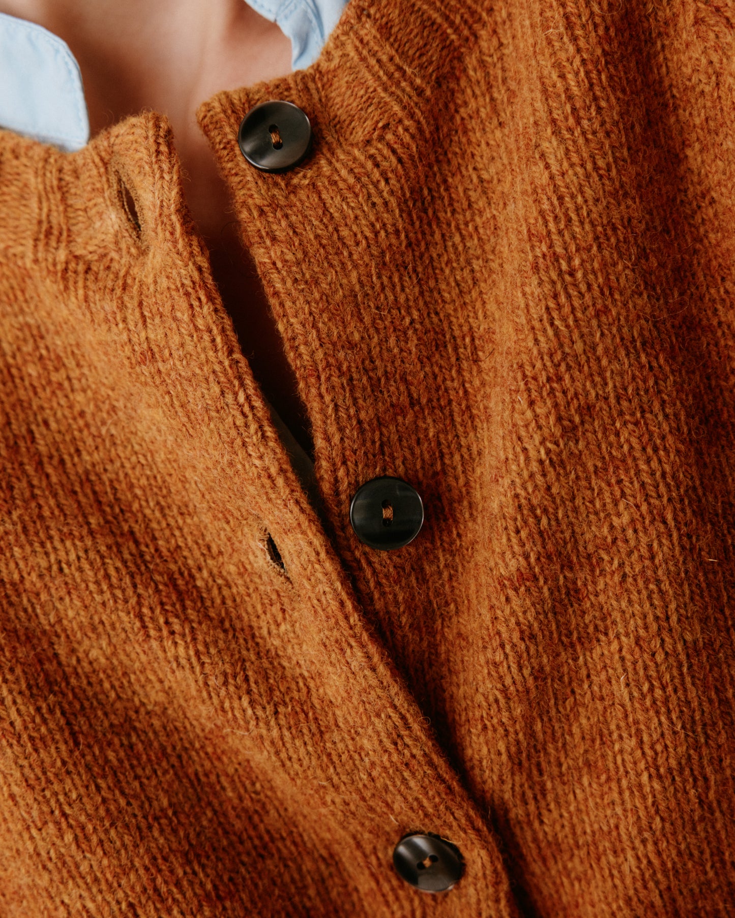 A model wearing a Bosie Womens Harley of Scotland Shetland Crew Neck Cardigan in colour Gold Dust / Cummin.