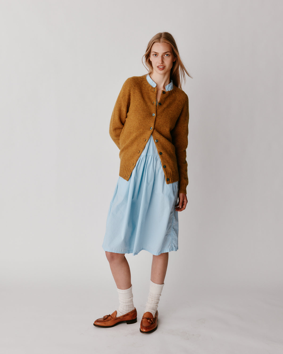 A model wearing a Bosie Womens Harley of Scotland Shetland Crew Neck Cardigan in colour Gold Dust / Cummin.
