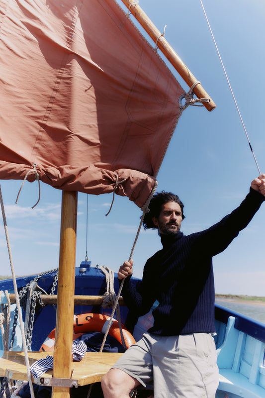 Man wearing a Blue Mogganer Diver navy ribbed polo neck Geelong Sweater by Bosie Knitwear