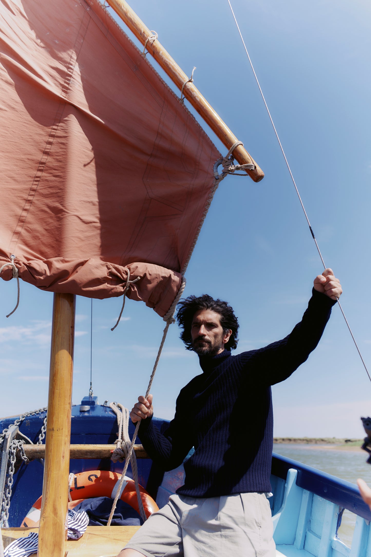 Man wearing a Blue Mogganer Diver navy ribbed polo neck Geelong Sweater by Bosie Knitwear