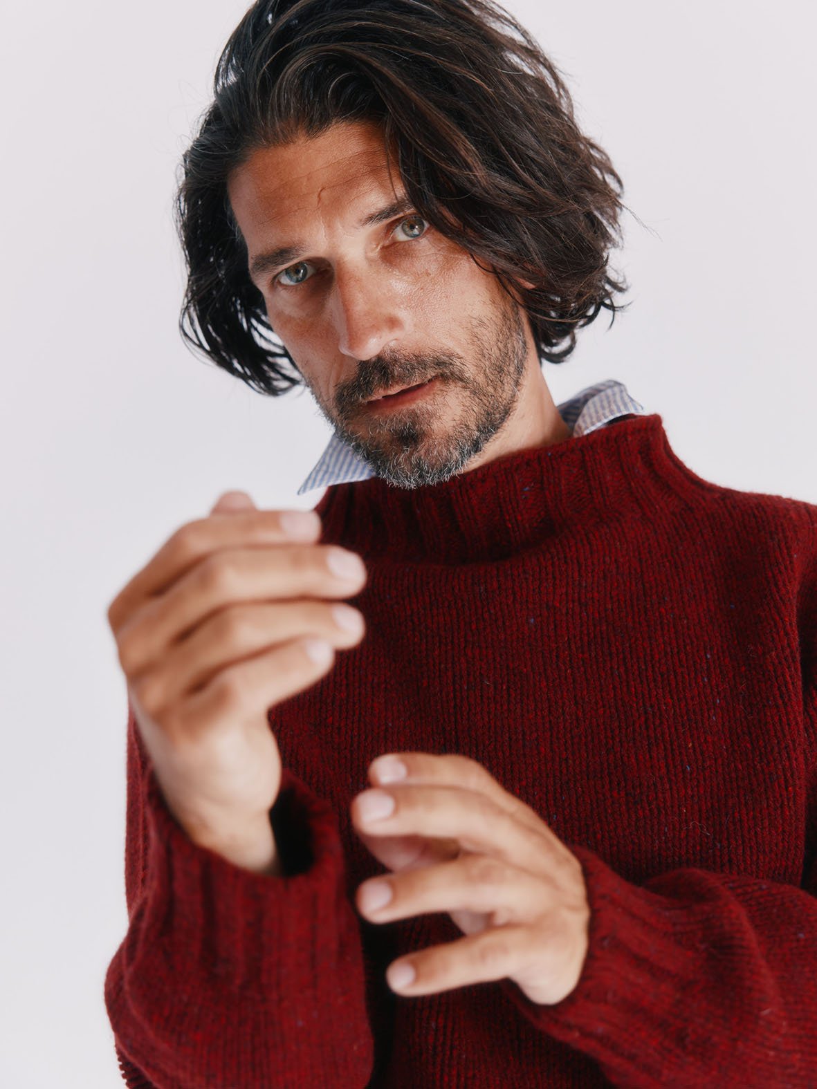 Man wearing a Blue Mogganer Lighthouse Chunky Glenugie Nep Sweater in Tiree Red by Bosie Knitwear