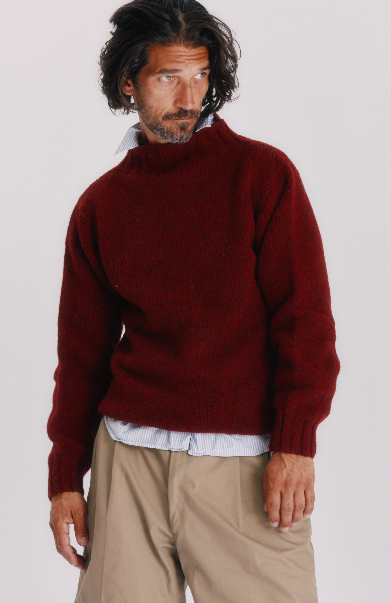 Man wearing a Blue Mogganer Lighthouse Chunky Glenugie Nep Sweater in Tiree Red by Bosie Knitwear