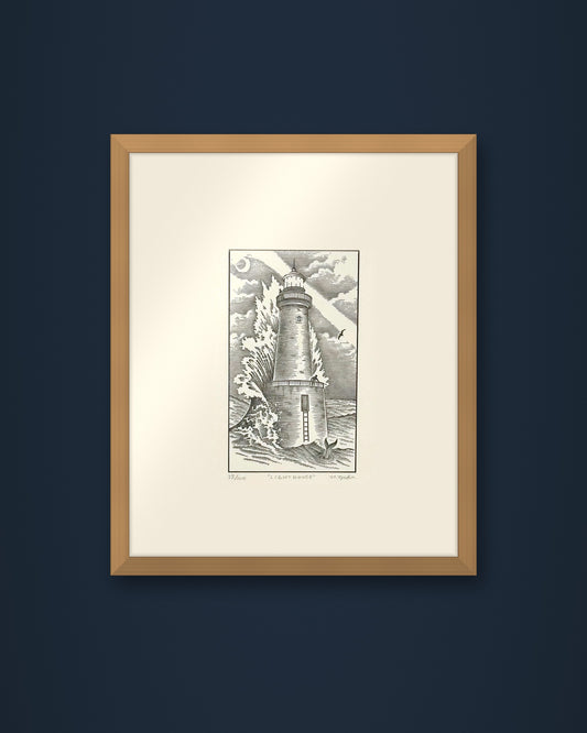 The Lighthouse: hand-pressed, hand-signed limited edition print of Nathan Yoder's hand-drawn illustration for Bosie Knitwear's Blue Mogganer collection, shown in an oak frame on a navy wall (frame not included)