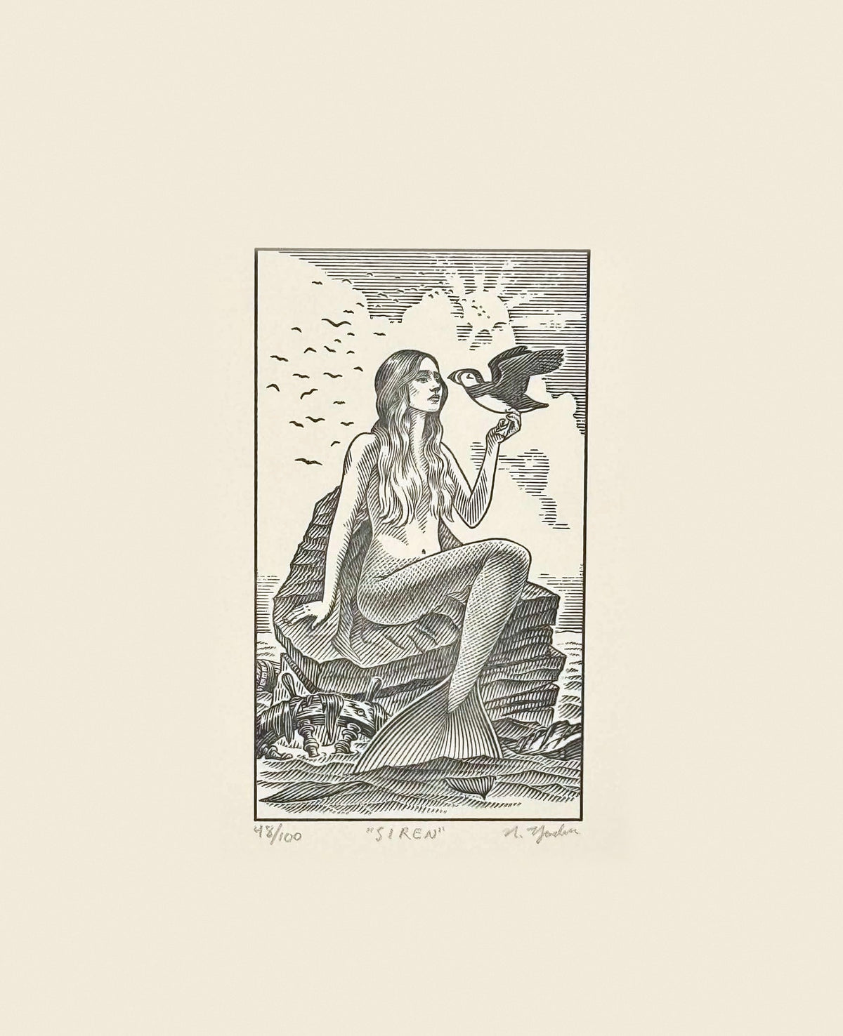 The Siren: hand-pressed print of Nathan Yoder's hand-drawn mermaid on the rocks holding a puffin, titled, numbered and signed in pencil, limited edition of 100 by Bosie Knitwear