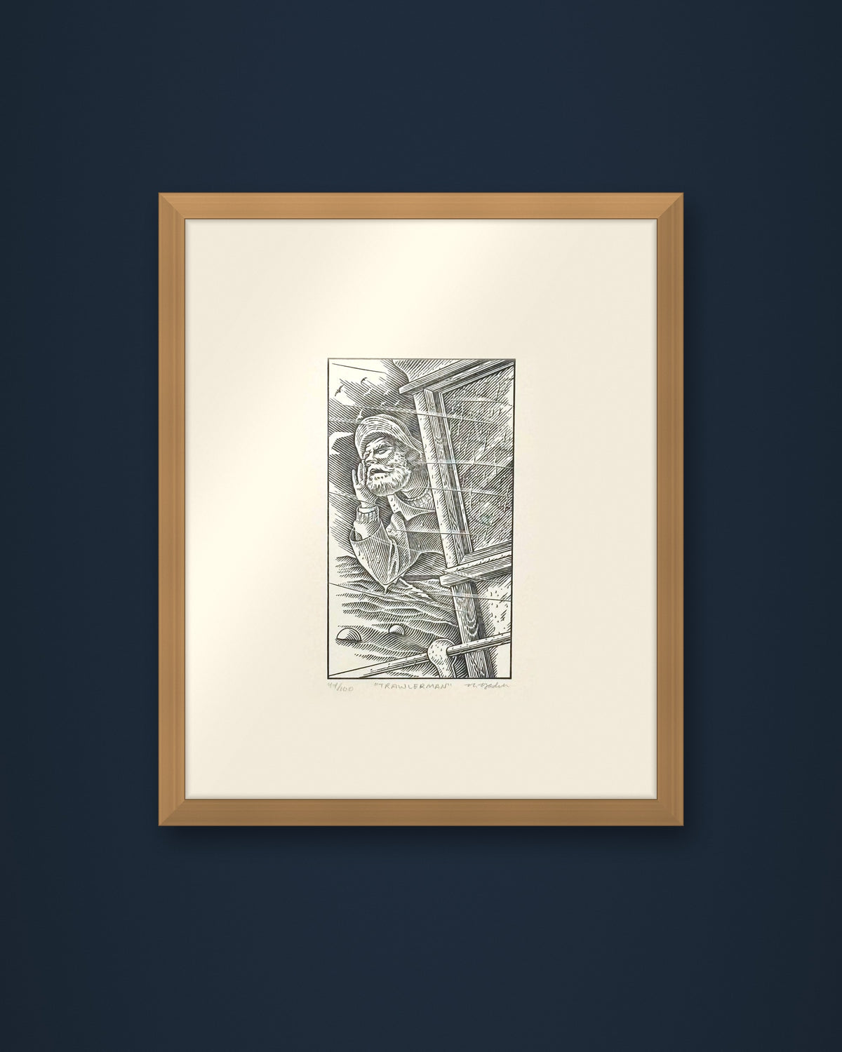 The Trawlerman: hand-pressed, hand-signed limited edition print of Nathan Yoder's hand-drawn illustration for Bosie Knitwear's Blue Mogganer collection, shown in an oak frame on a navy wall (frame not included)