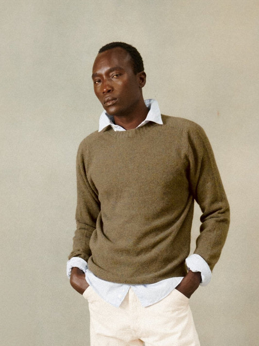 Model wearing the Bosie Harley of Scotland x Todd and Duncan Pure Men's Cashmere Sweater in Tarp Bronze – seamless, seam-free pure cashmere, knitted in Scotland by Harley of Scotland
