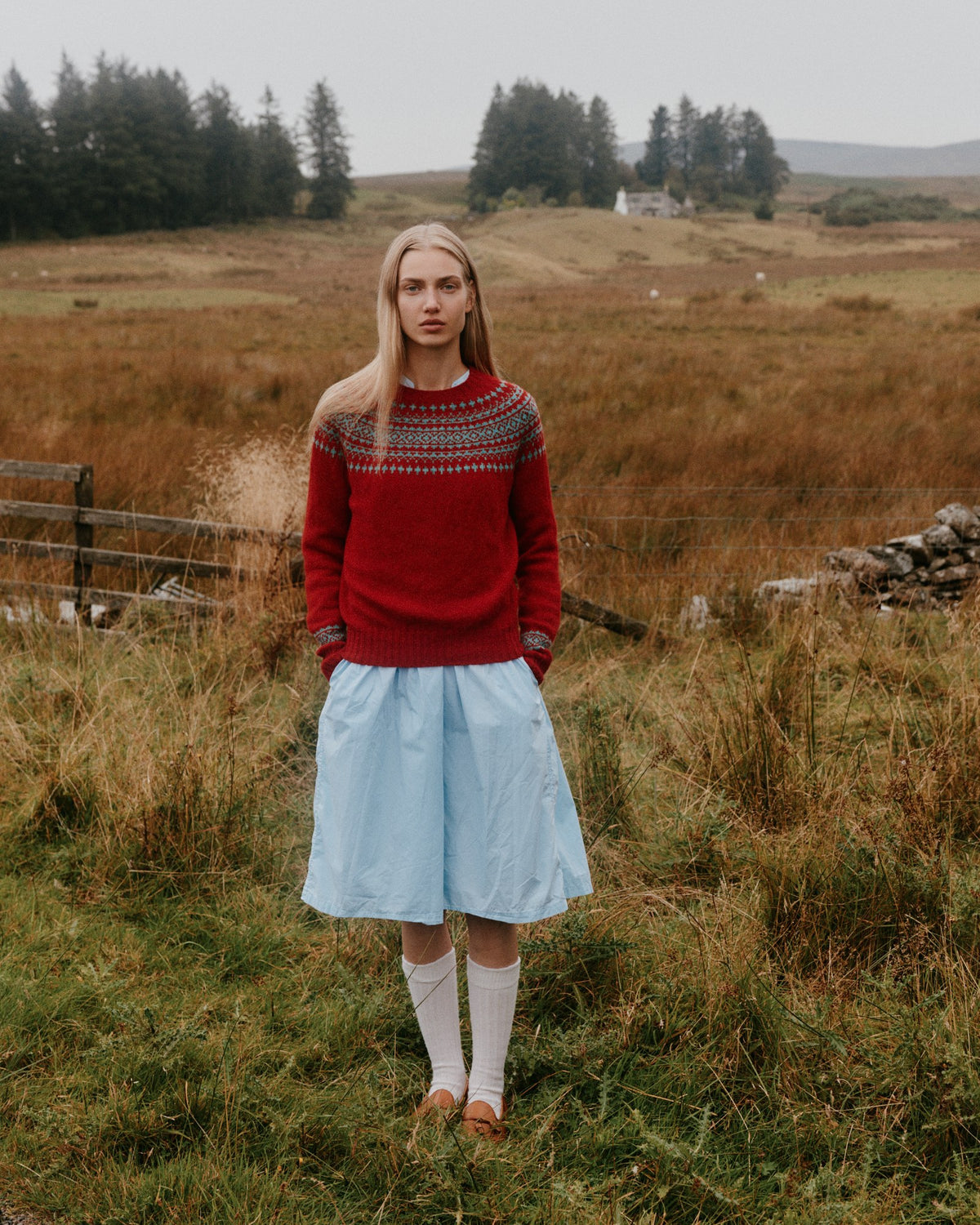 Model wearing the Bosie Hara Yoke Fair Isle Women's Sweater in French Red – seamless, seam-free pure wool, knitted in Scotland by Harley of Scotland for Bosie Knitwear