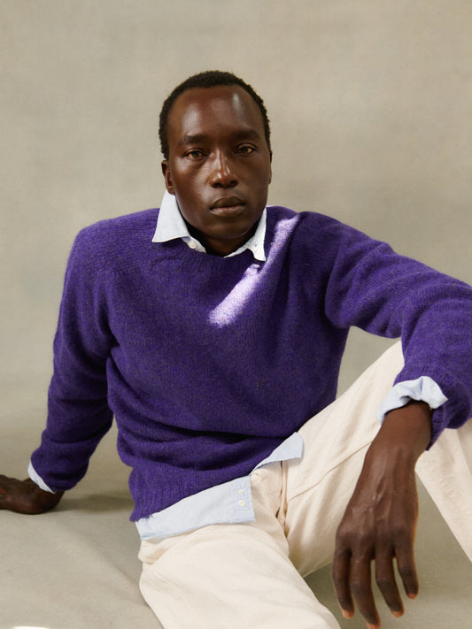 Man wearing a Bosie Knitwear Harley of Scotland seamless saddle shoulder men's Shetland sweater jumper in Royal Violet Purple