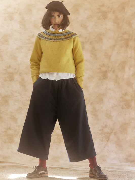 Woman in Bosie Knitwear Skye Sweater in Nugget Gold